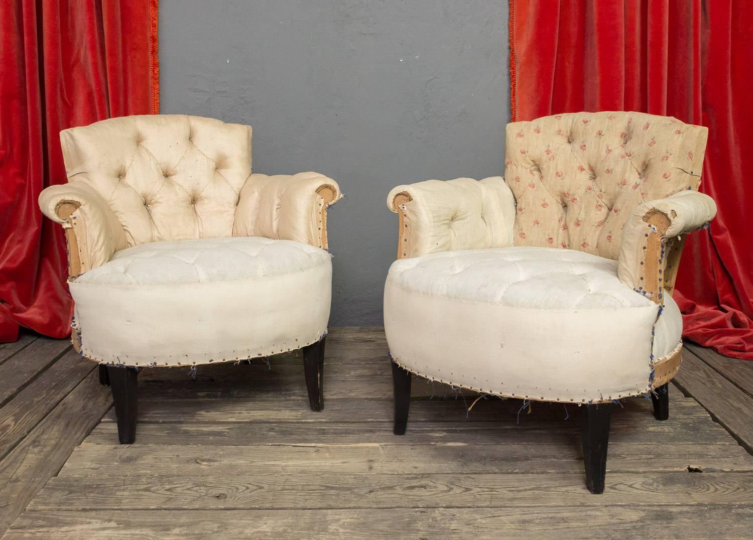 Pair of petite, 1930s tufted armchairs. Fabric has been stripped and the chairs are upholstery ready. 