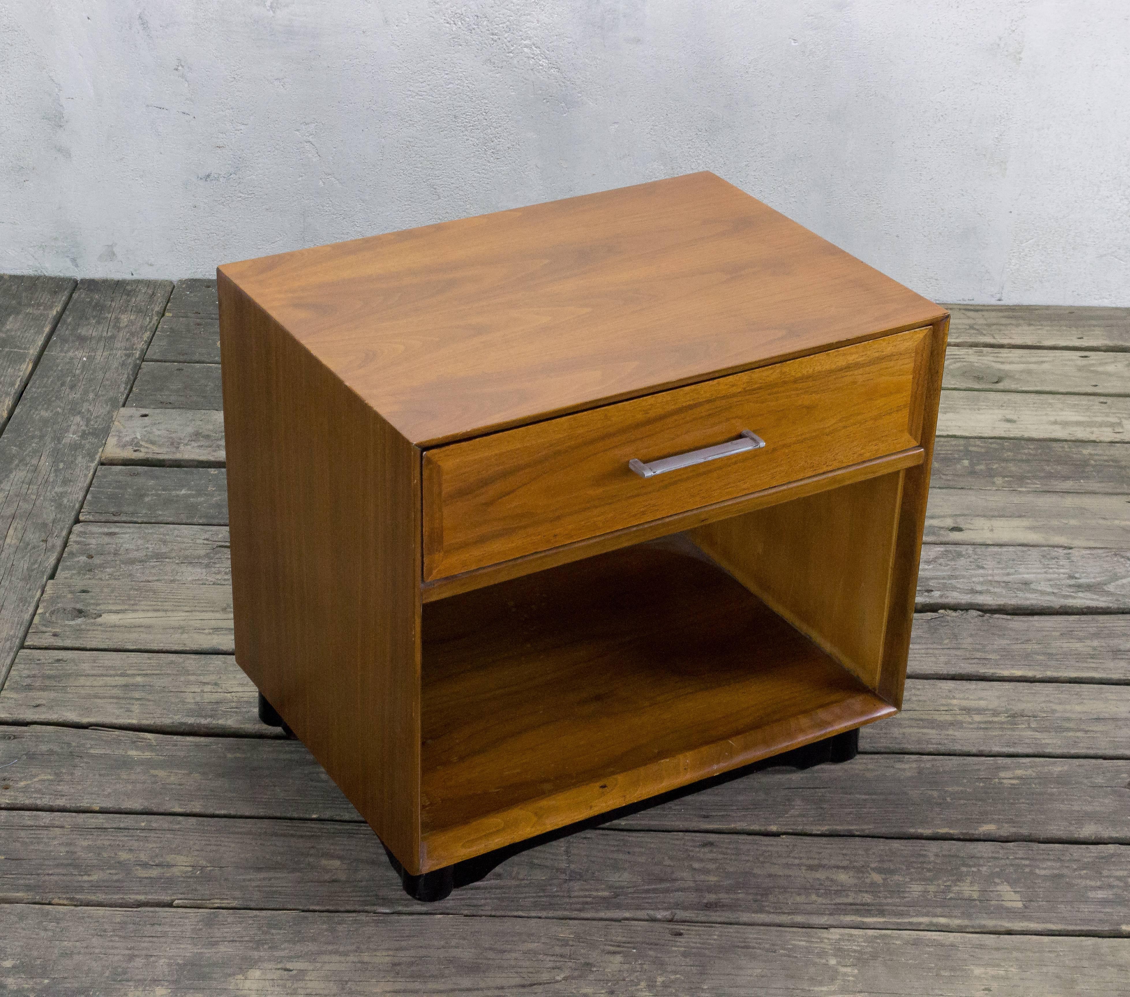 Mid-Century Modern nightstand with a single drawer and an ebonized base.