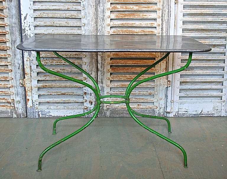 Garden table with  zinc top and vintage green paint.   French, 1920's, the top is more recent.  The table is in very good condition, shows signs of normal wear.