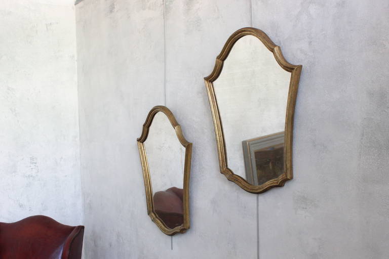 Pair of antique shield form mirrors in giltwood frames. French, mid 20th century. Good condition. Age is very visible within the glass and has a fog like appearance.

Ref #: DM0405-18

Dimensions: 26”H x 20