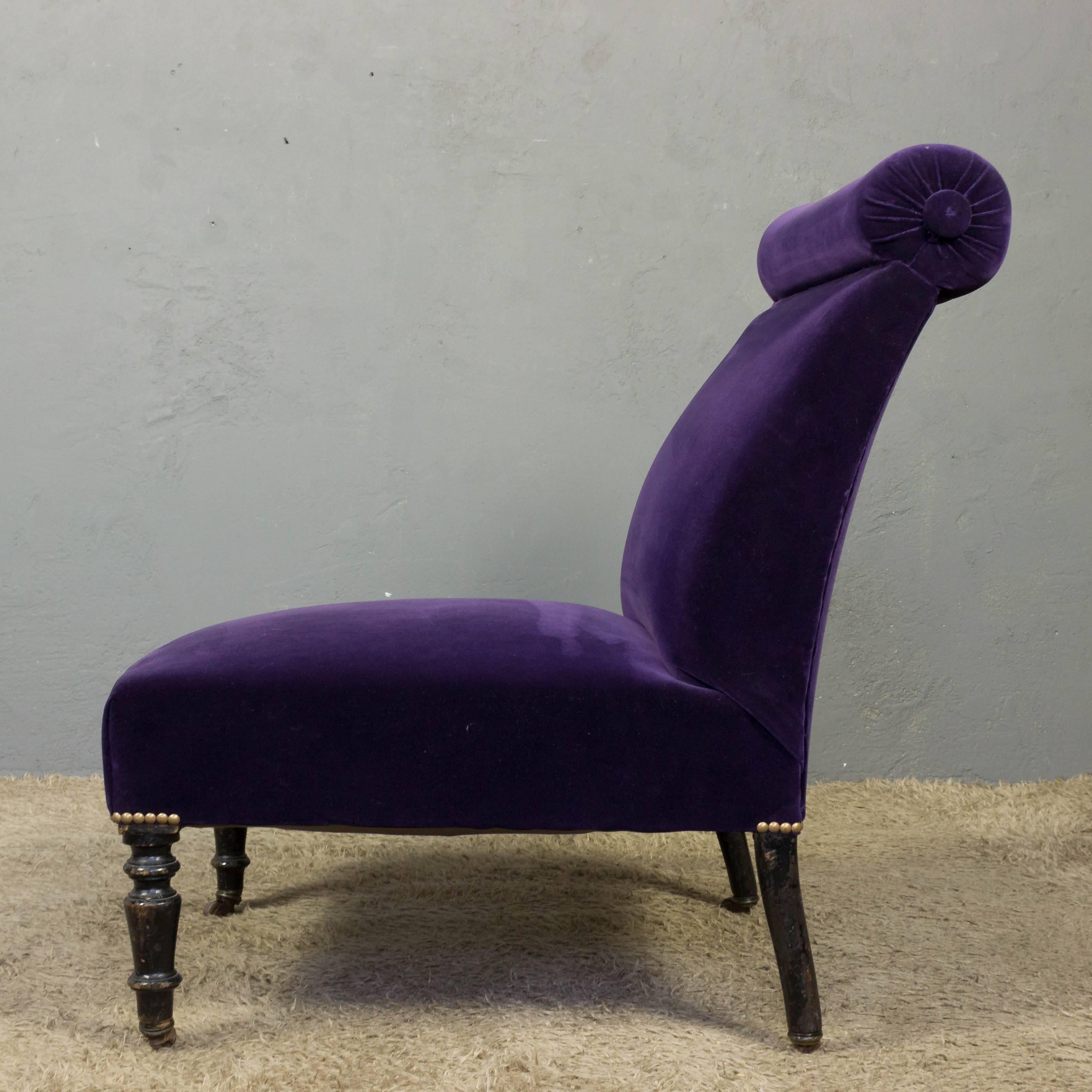 19th century slipper chair upholstered in an eggplant velvet with brass nailheads.


   