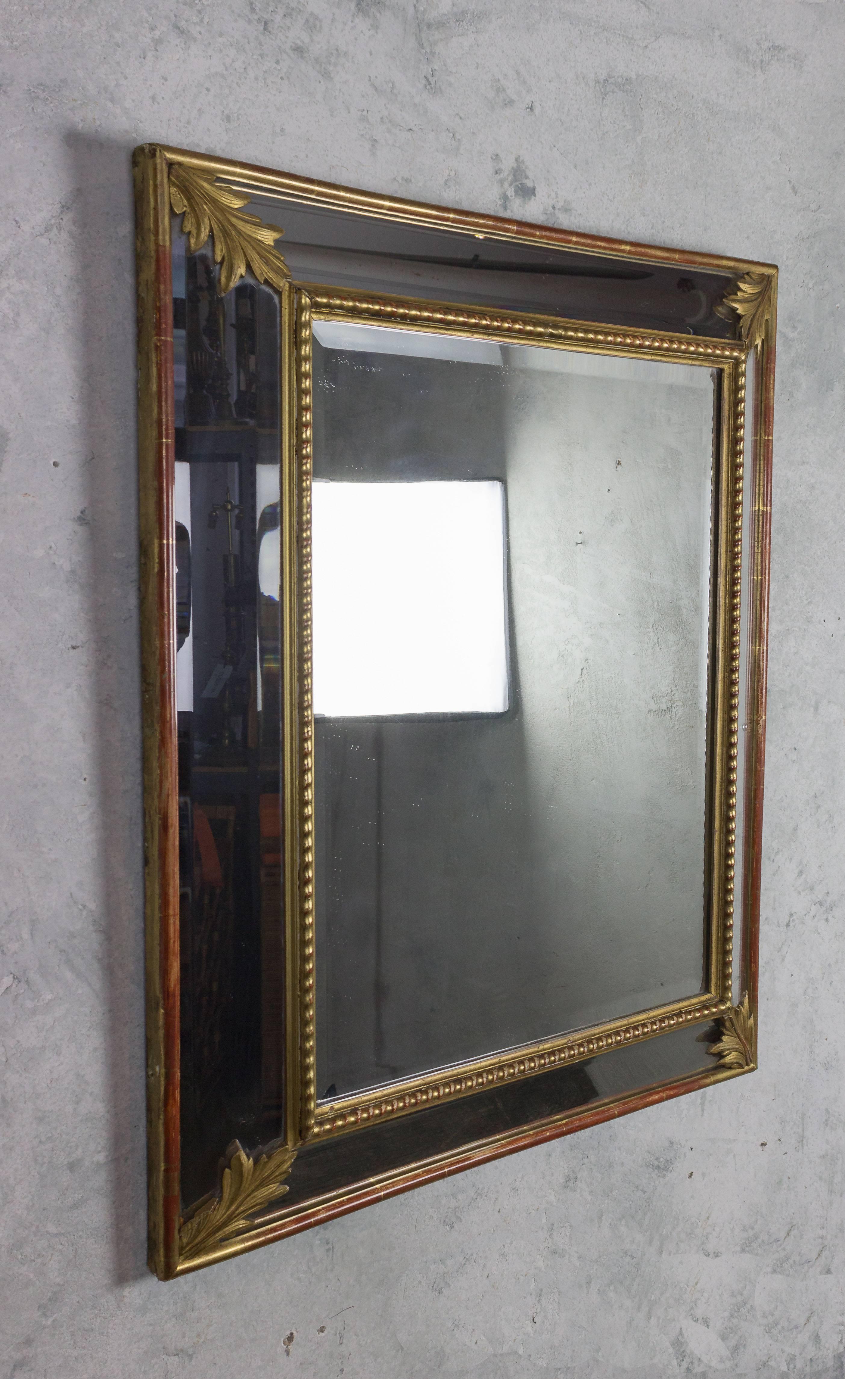 Elegant French carved and beveled giltwood mirror with inset mirrored panels.