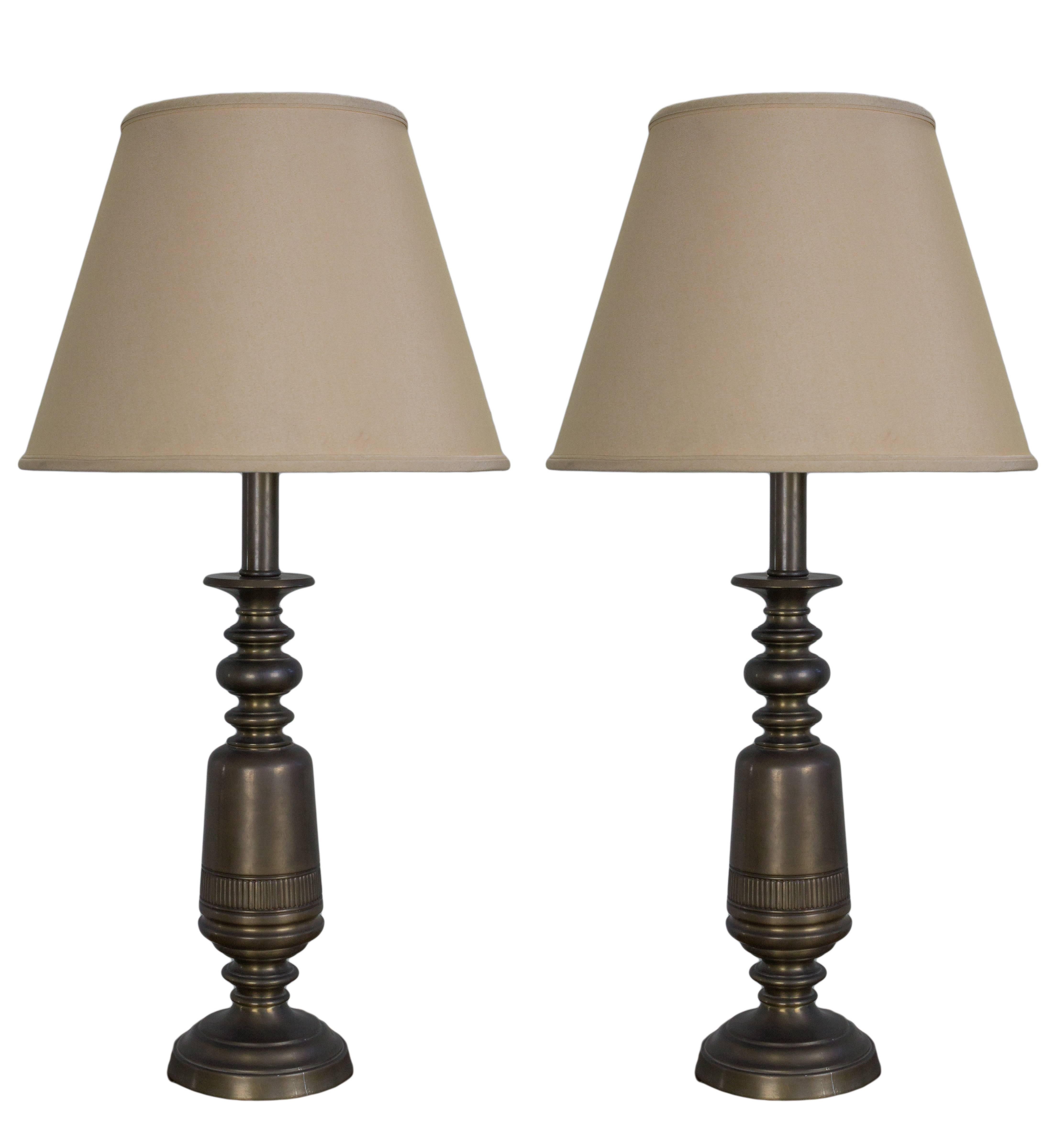 This handsome pair of American 1950s lamps possess an air of timeless charm. Finished in an elegant English brass, these lamps exude sophistication and style. In good vintage condition, they have been carefully preserved and are ready to grace your