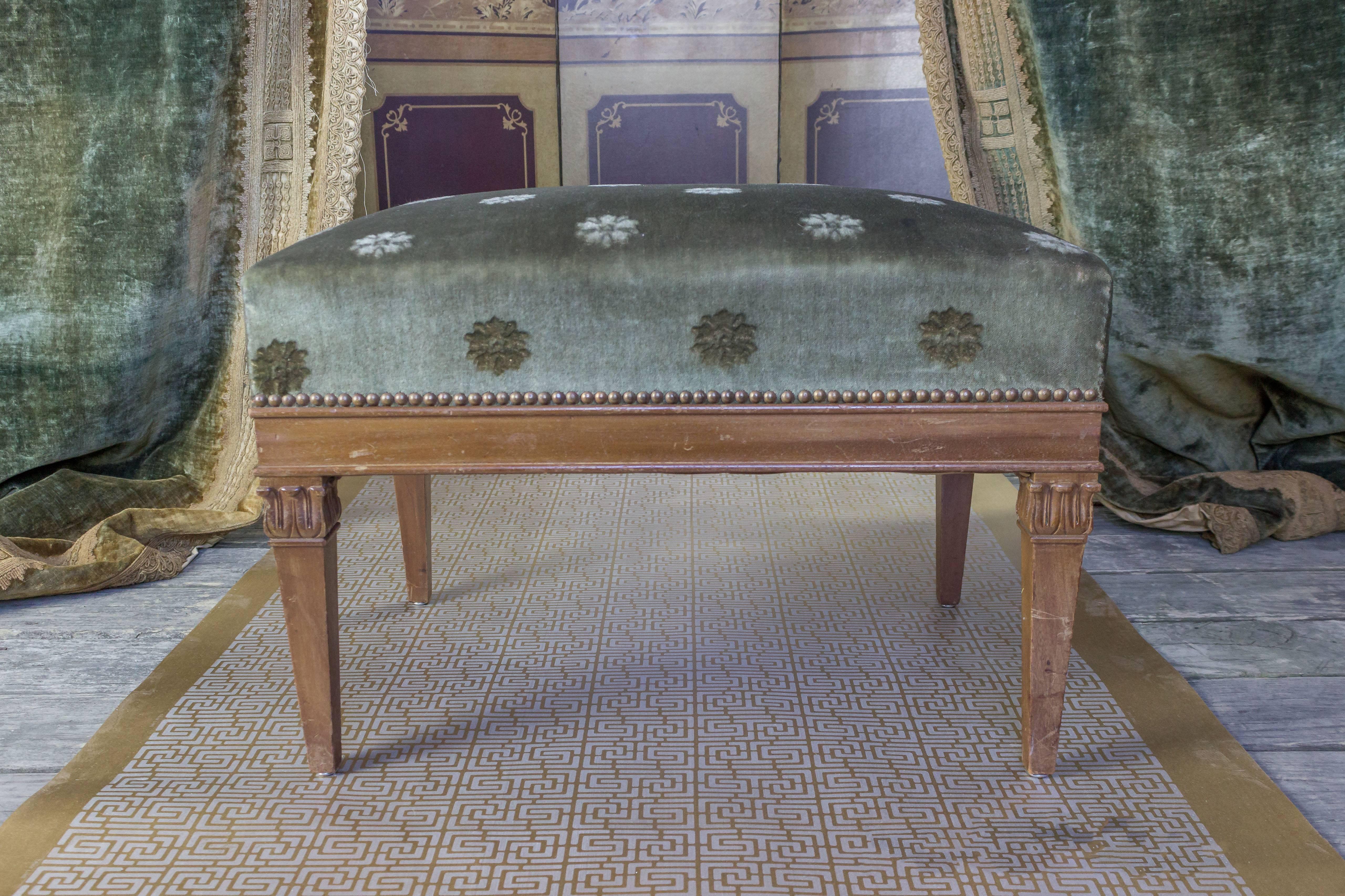 A French neoclassical-style bench with upholstered seat and nailhead detailing. Make any room grand with this exquisite neoclassical-style bench from France. The frame needs polishing, but the upholstered seat with the nailhead detailing gives it a