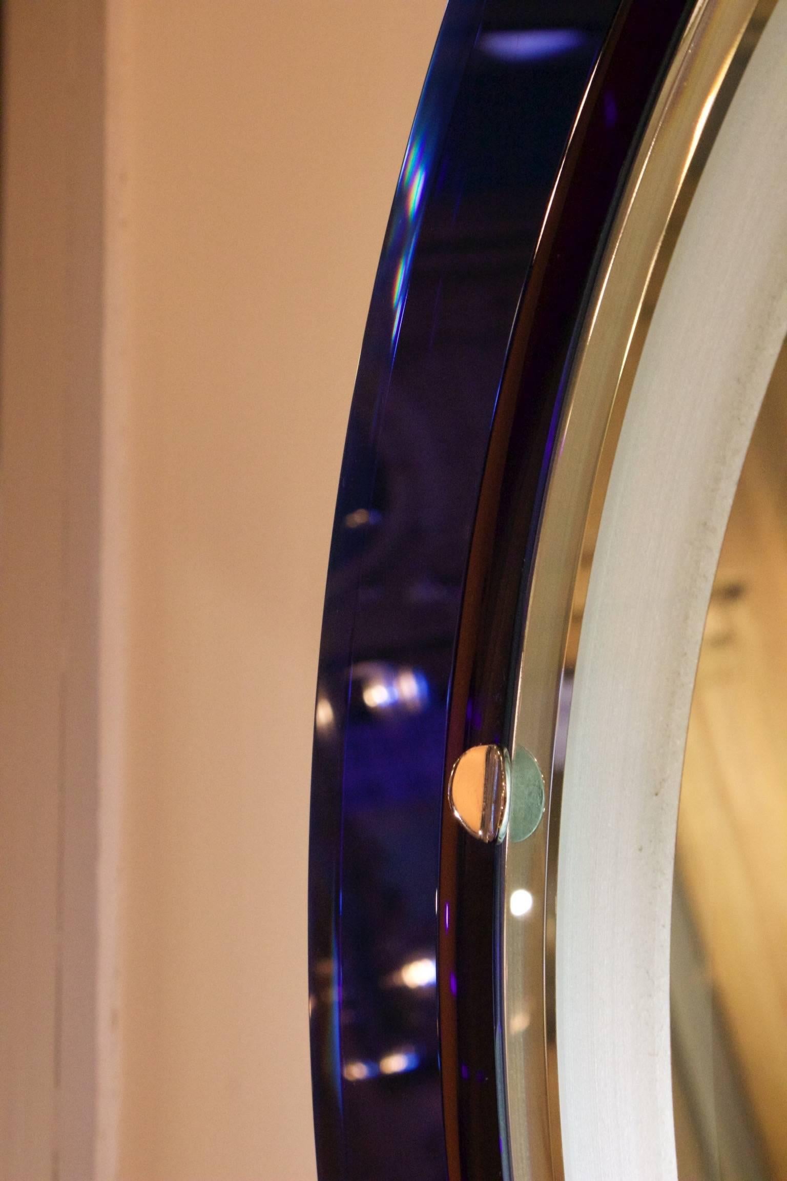 Very unusual mirror with a cobalt blue and white glass frame. The mirror has a backlight, Italian, 1970s.