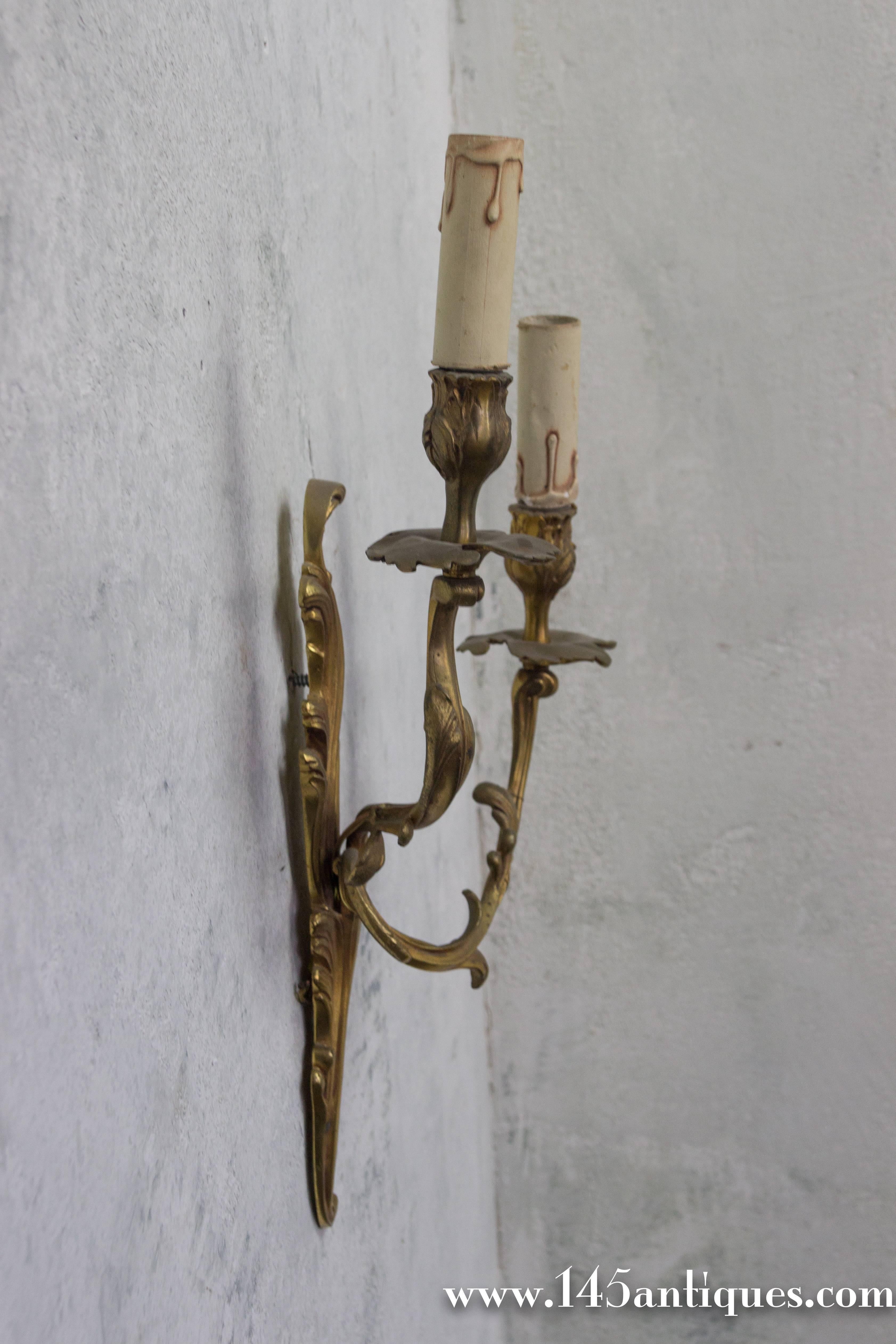 Elegant pair of French 1920s gilt bronze sconces with two arms in the Louis XV style. Very good vintage condition, but will need to be wired.

Ref #: LS0408-09

Dimensions: 19