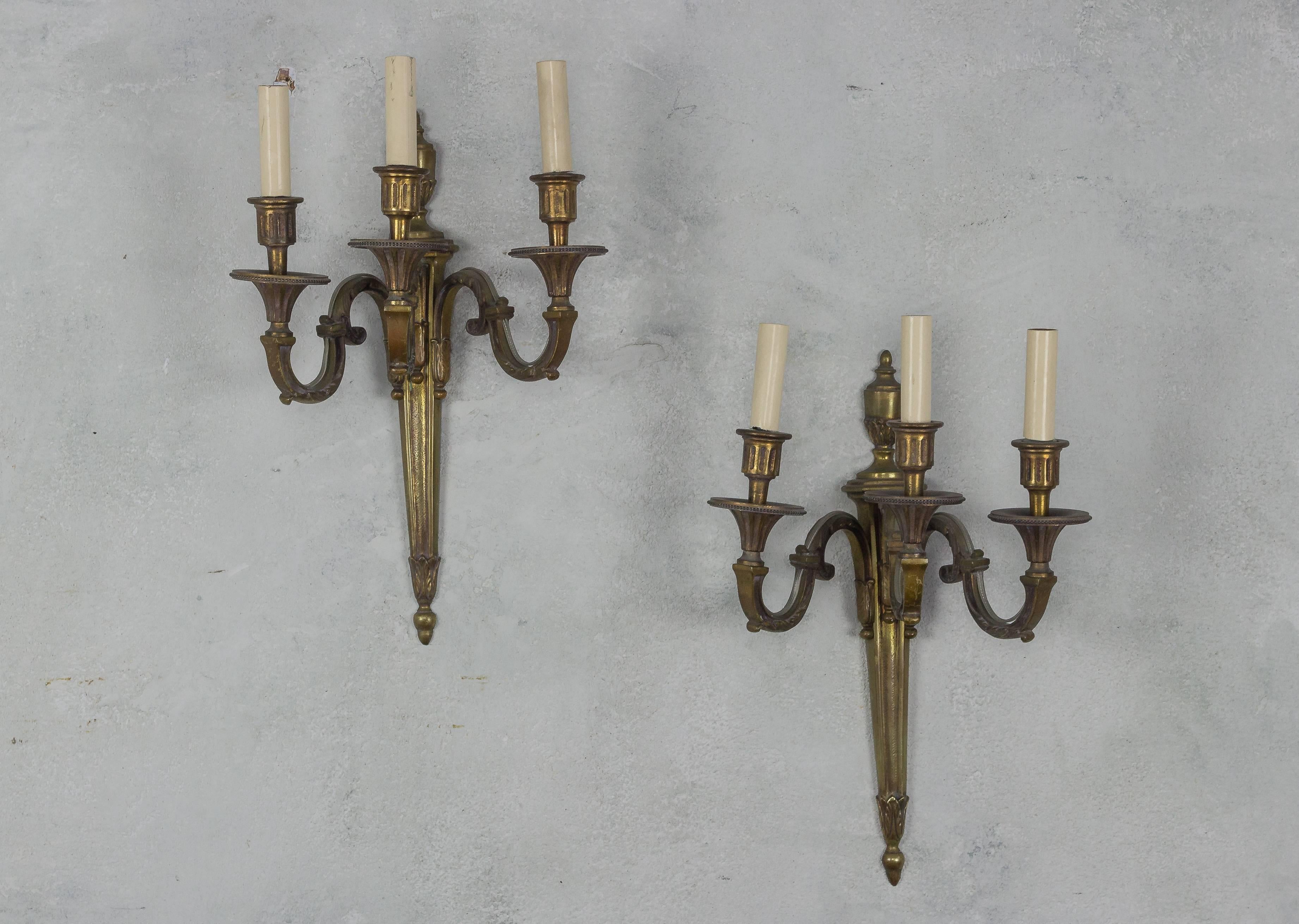 Handsome pair of French 1920s gilt bronze three armed sconces in the Louis XVI style. Very good vintage condition. Wired for showroom display, not UL code.

Ref #: LS0408-05

Dimensions: 16