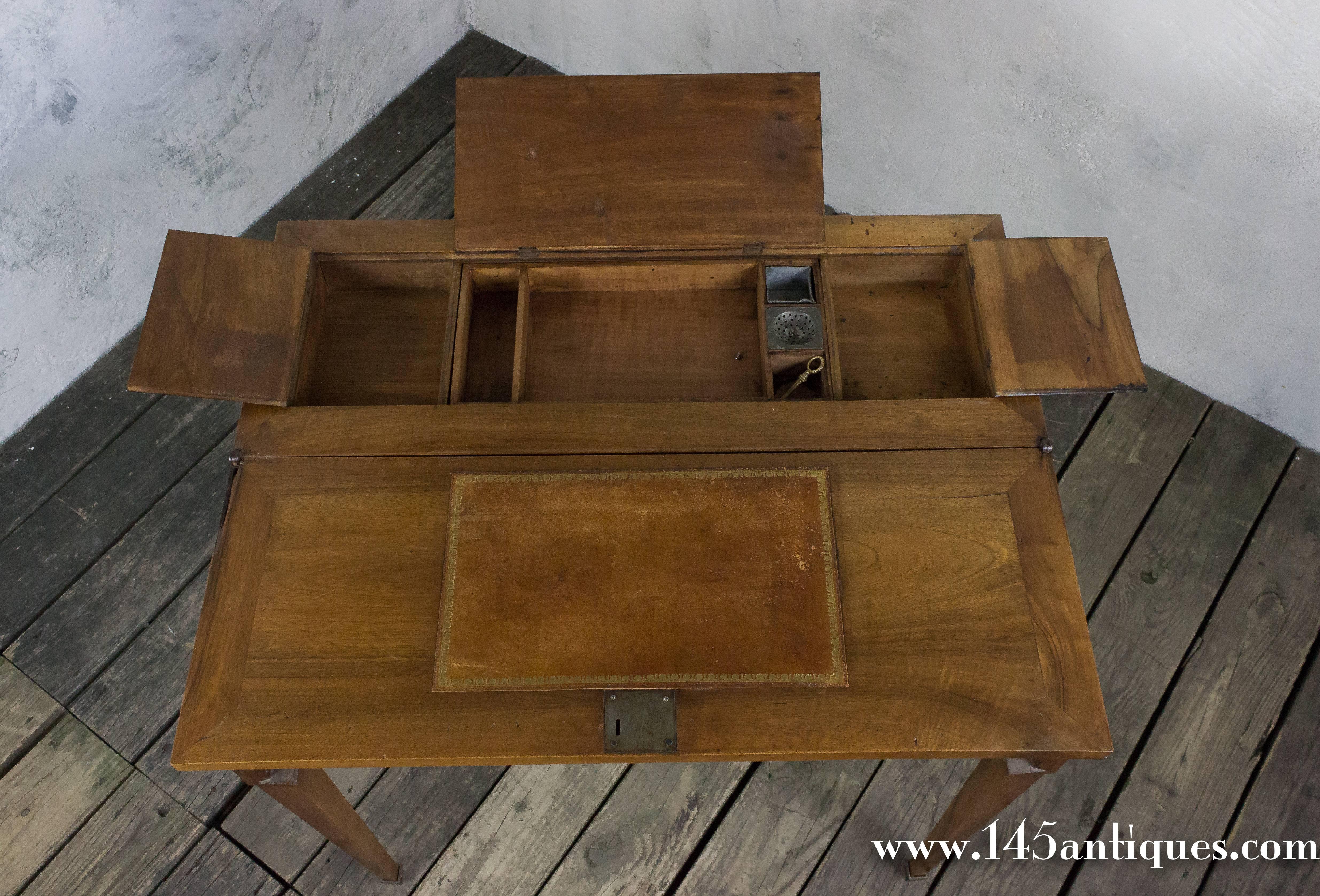 Compact French writing desk with drawers for paper and pens and hidden drawers on the side. Opens to desk 24