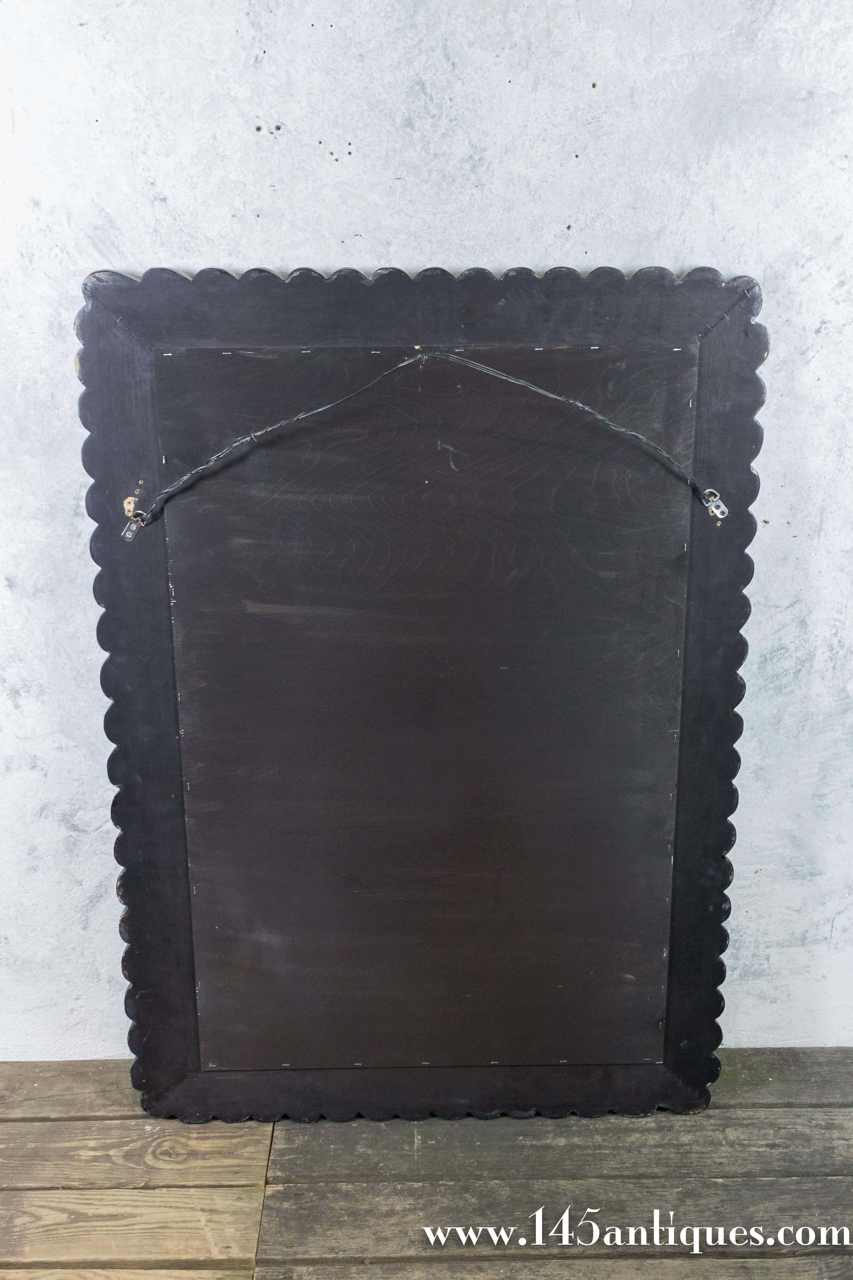 American Ebonized Carved Mirror with Gilt Highlights