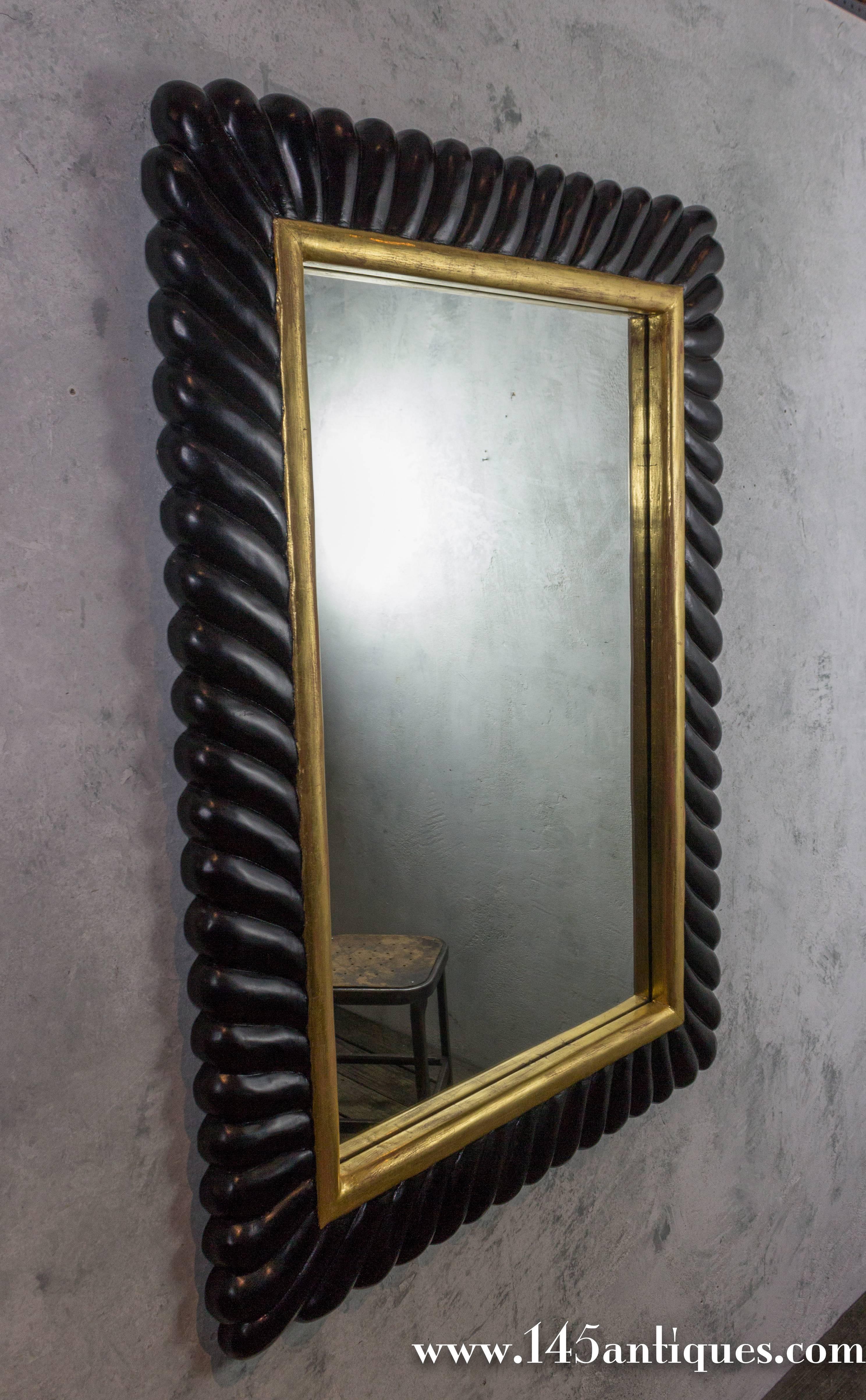Modern Ebonized Carved Mirror with Gilt Highlights