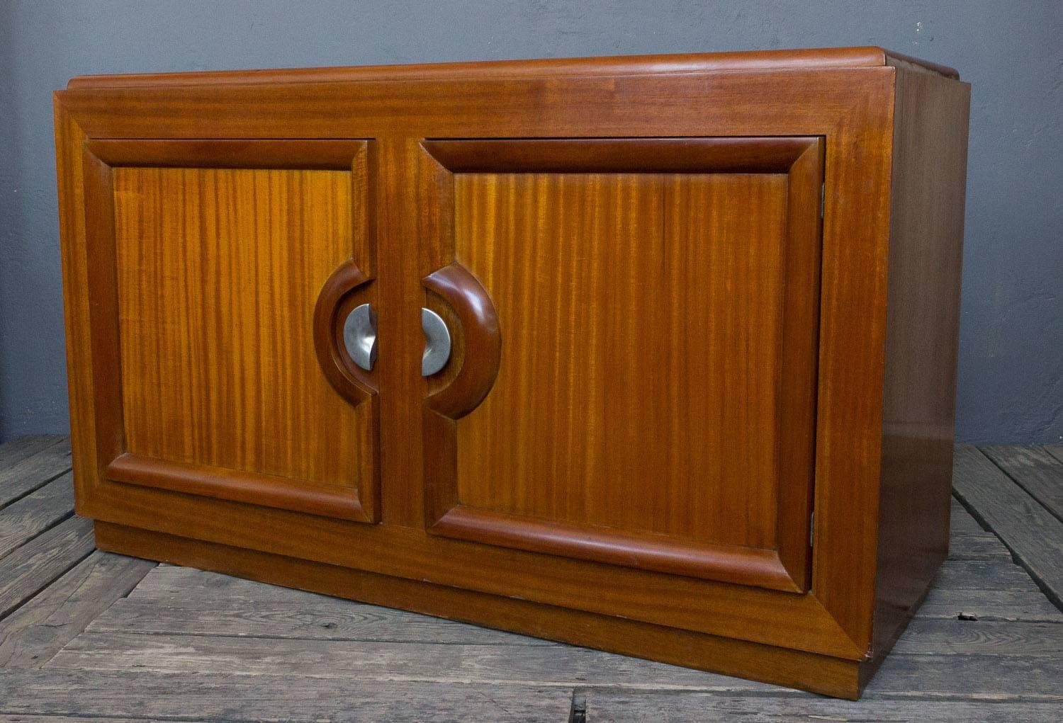 Mahogany server by Paul Laszlo. Interior divided with two compartments; one shelf on the left and four pull-out drawers on the right side. Discounted price is final net.