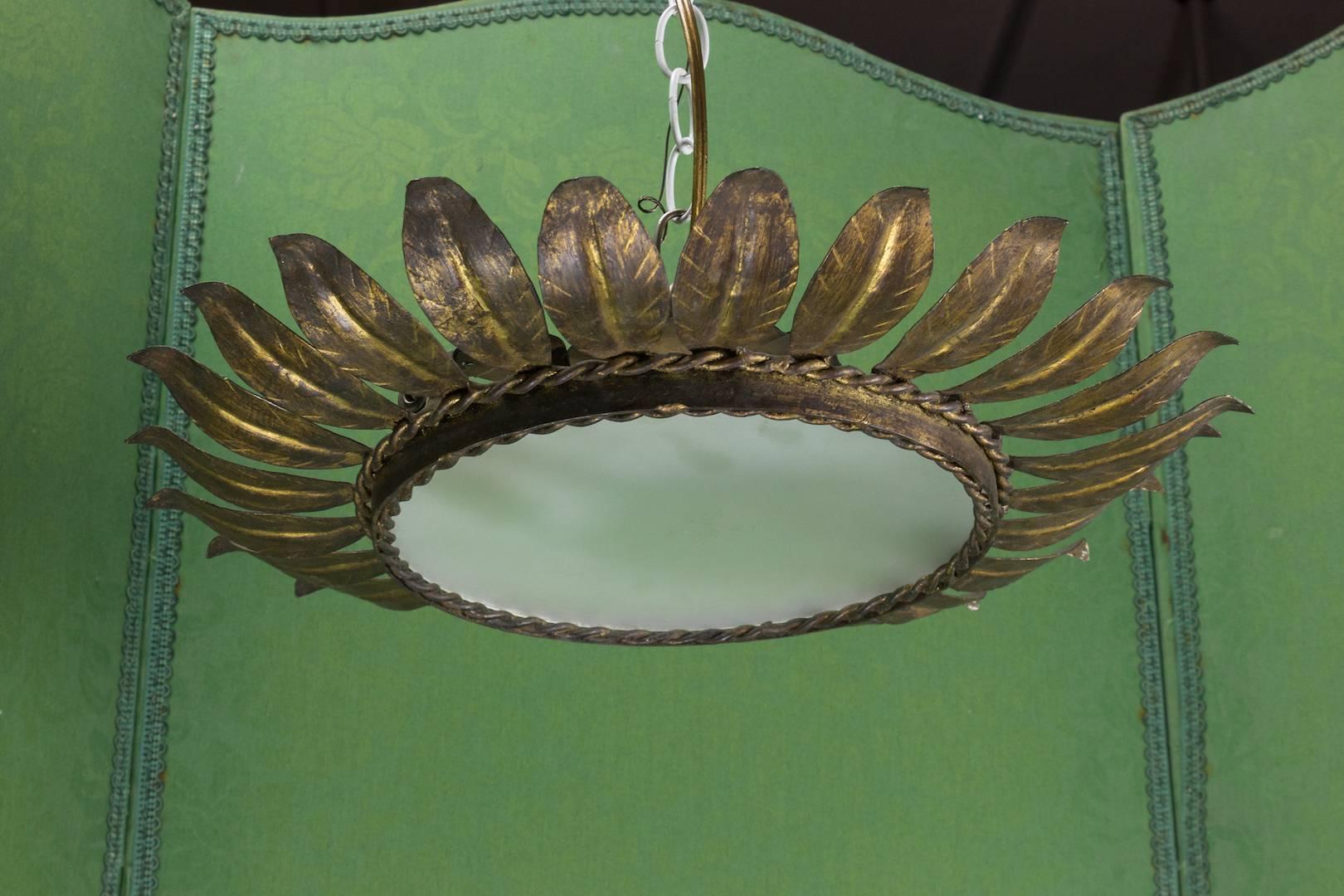 Spanish 1940s gilt sunburst ceiling fixture with round frosted glass; framed with two rows of braiding.

This fixture has been UL Certified Code Wired and is sold with a matching canopy.  UPS Shipping quote available on request.