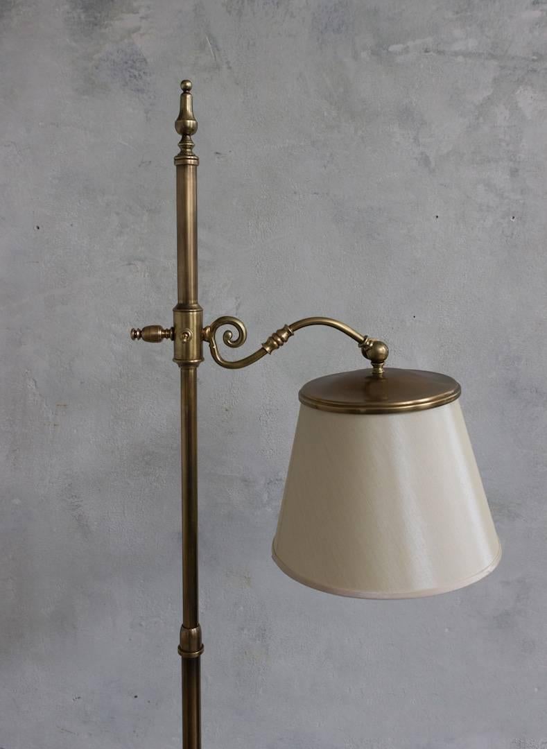 Adjustable English brass finish floor lamp with round base. This lamp has been UL wired and also features a new European style shade. The top of the lamp pulls up and down for an adjustable height ranging from 61