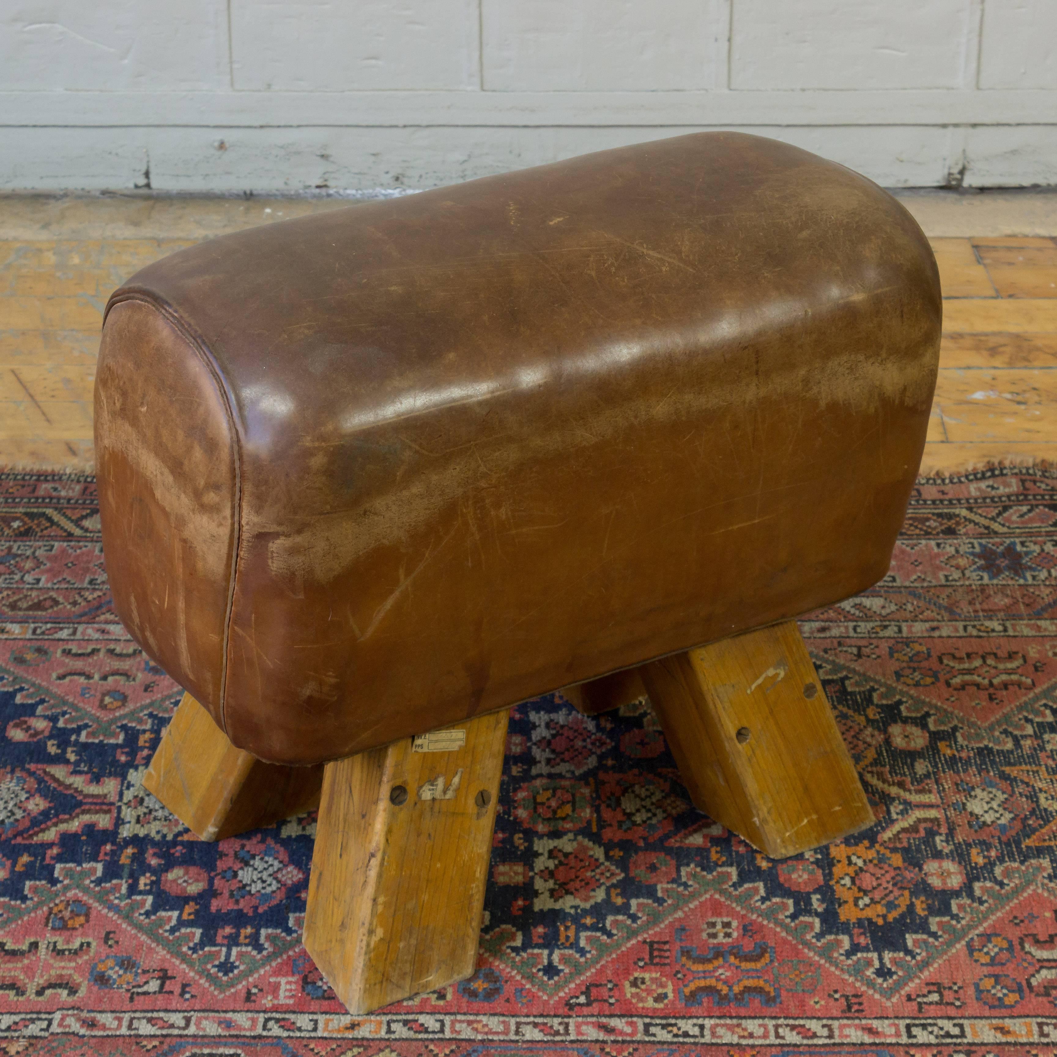 A small leather gym horse that has been converted to a bench. Add a unique piece of history to your home with this small leather gym horse bench. This gorgeous bench is an original from the early 20th century and was once used by French gymnasts as