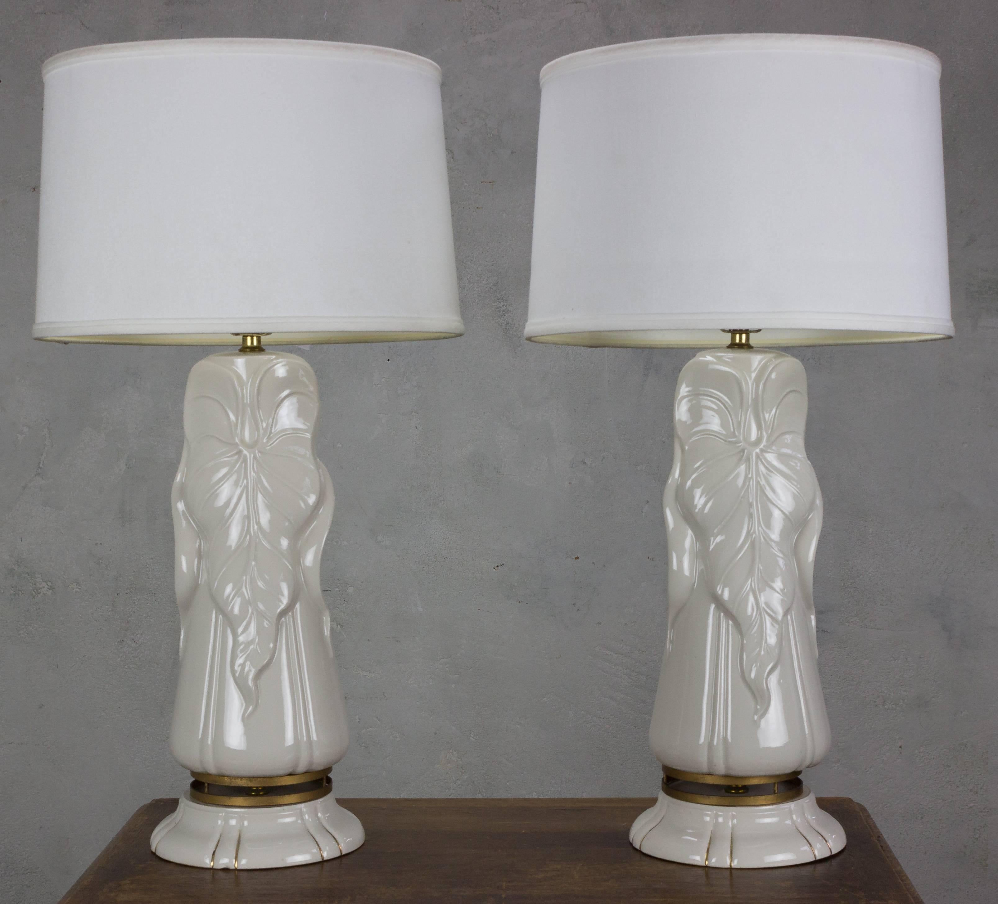 These 1940s American Hollywood Glam white ceramic lamps embody the glamour and elegance of old Hollywood. These vintage treasures are in very good vintage condition, preserving their allure from decades past. The white ceramic bodies, meticulously