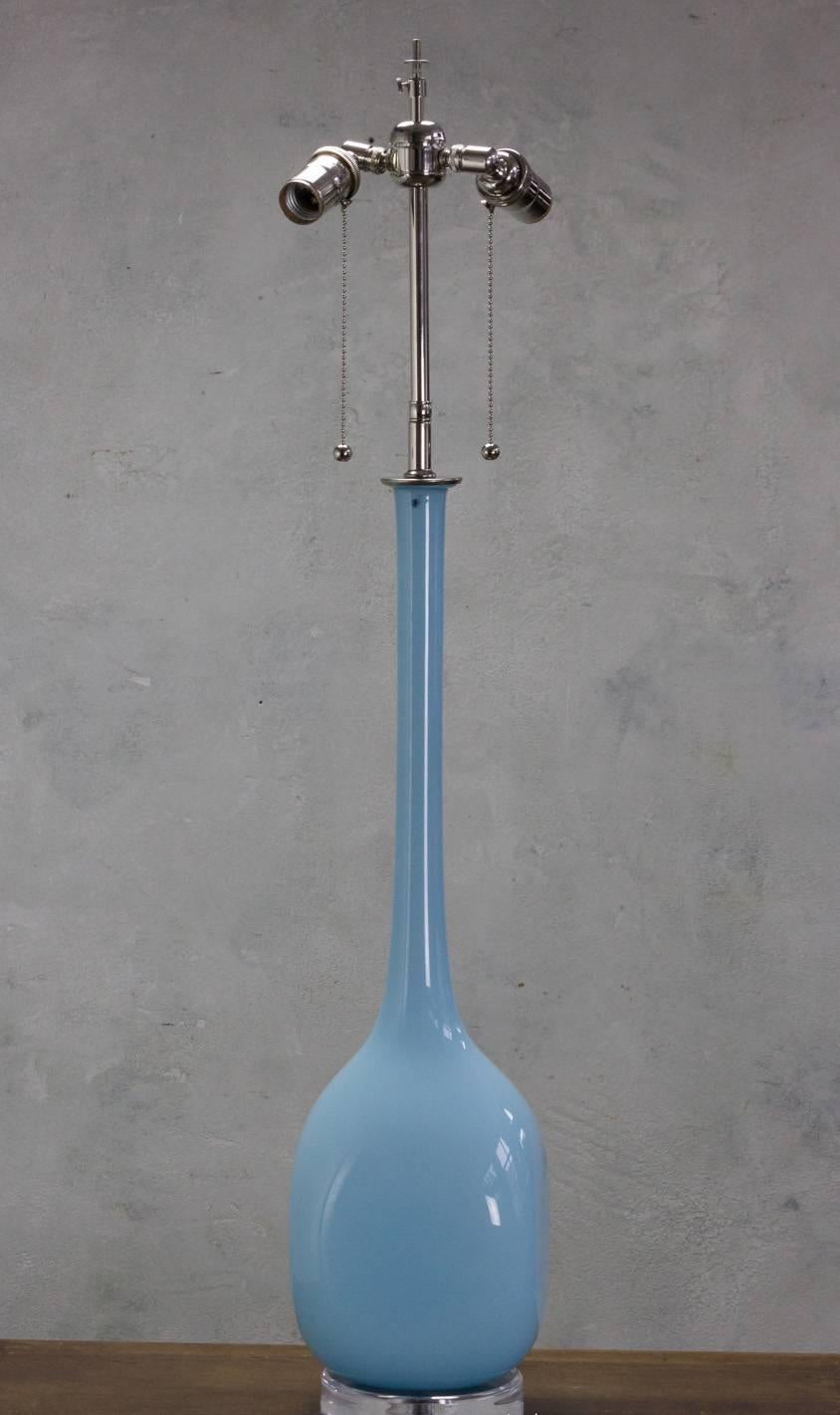 Tall pale blue pair of unusual Murano glass lamps on round Lucite base and nickel-plated hardware.