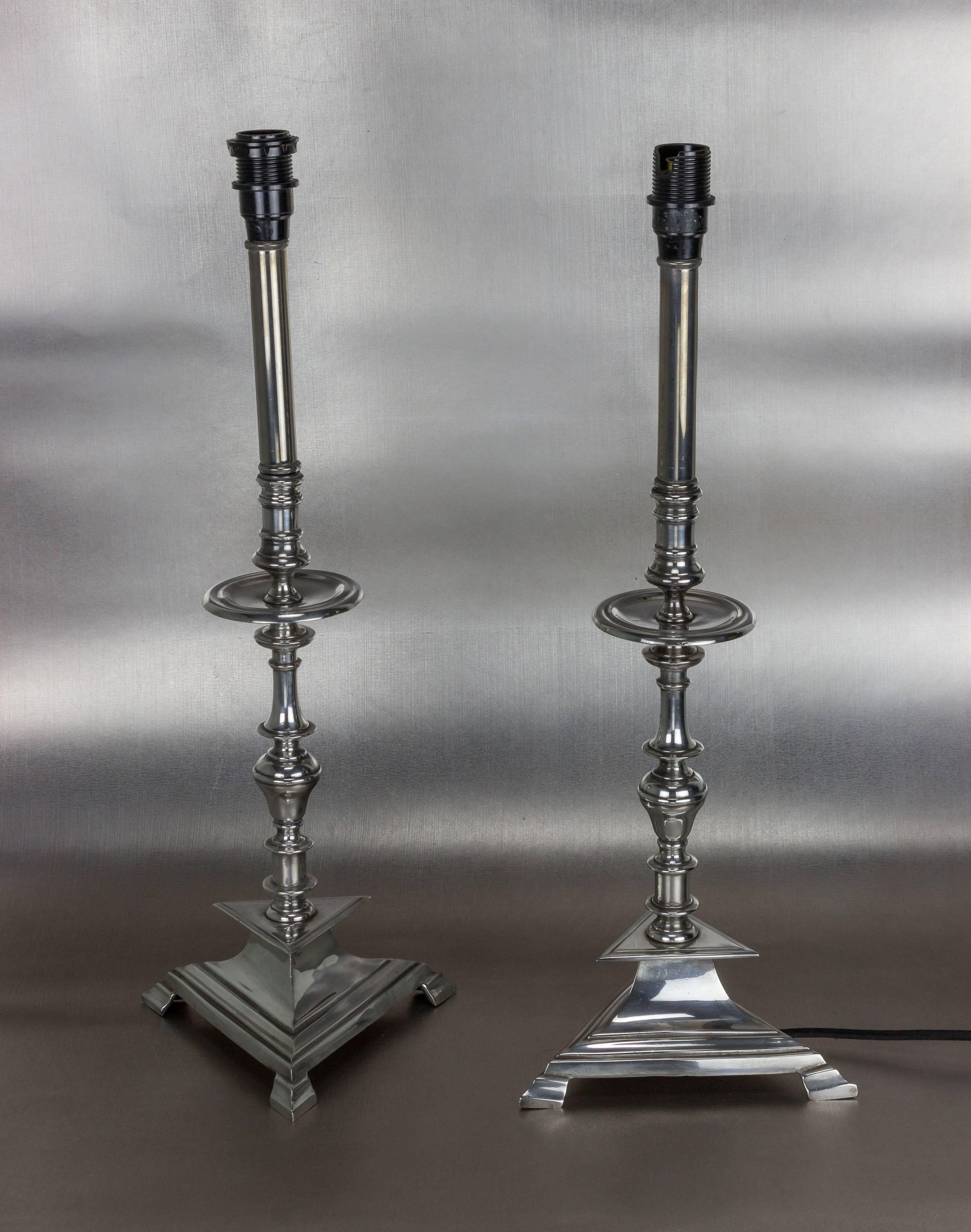 A stunning pair of restored nickel-plated French Art Deco table lamps. These Art Deco table lamps are a classic example of outstanding vintage lighting design. The footed triangular bases give the lamps a unique and angular look, while the nickel
