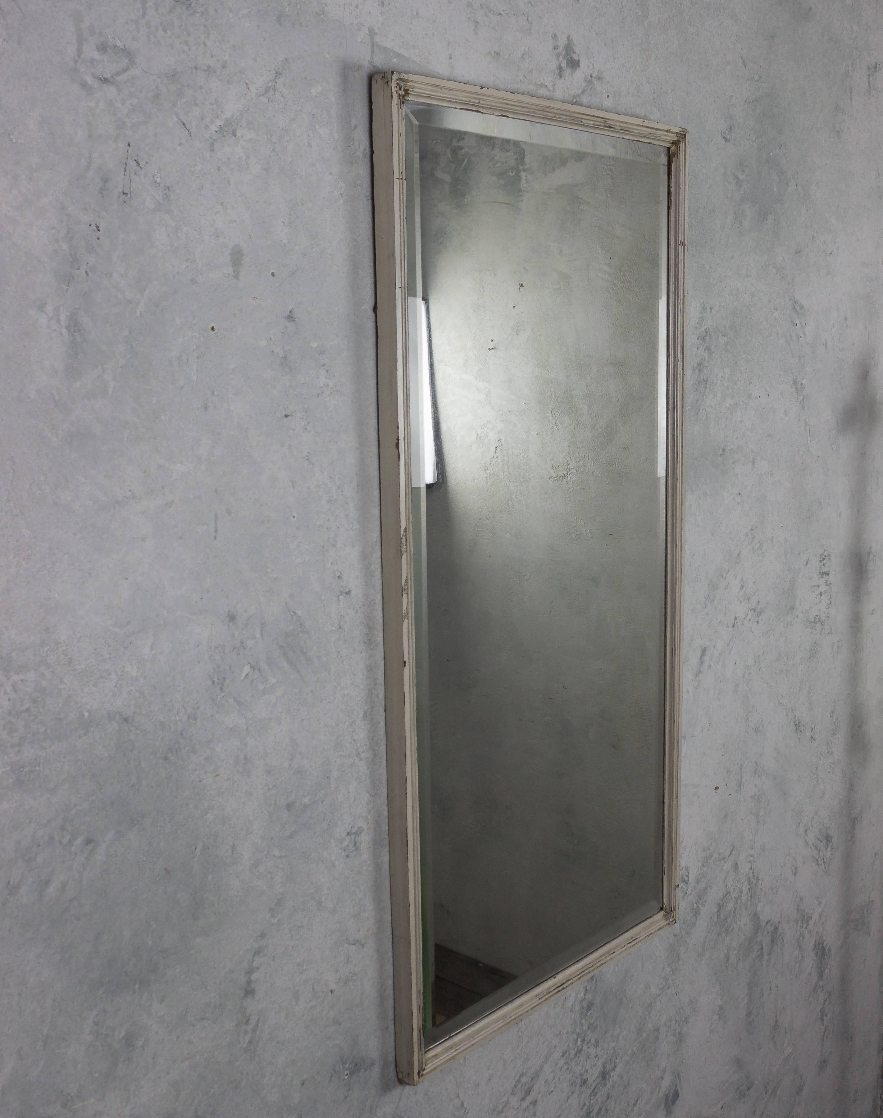 French early 20th century beveled mirror with a narrow white fluted frame. Vintage, mirror is heavily distressed.

Ref #: DM0310-01

Dimensions: 47.5”H x 23.5
