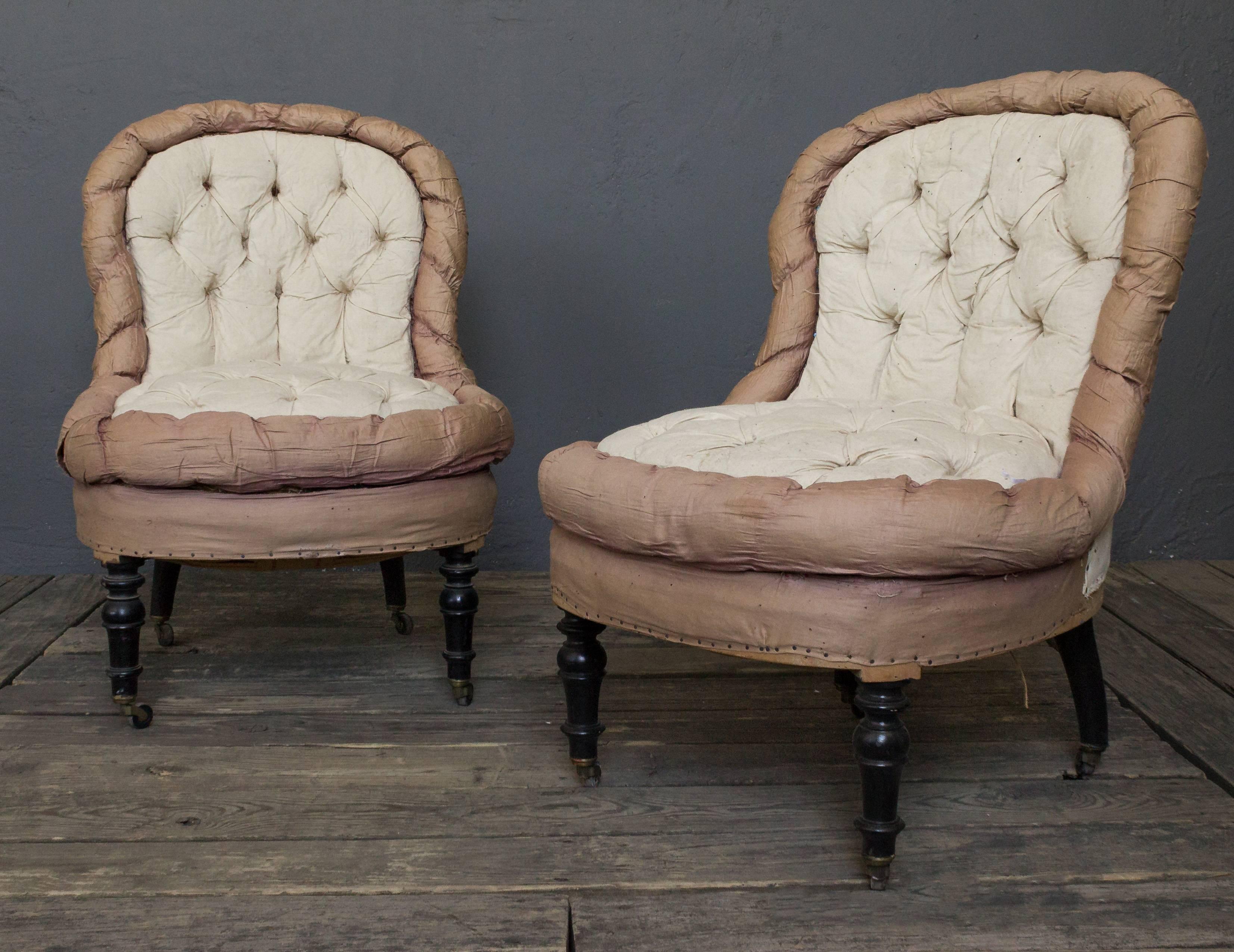 Pair of Napoleon III slipper chairs in muslin. The chairs are heavily tufts with a foxtail border.