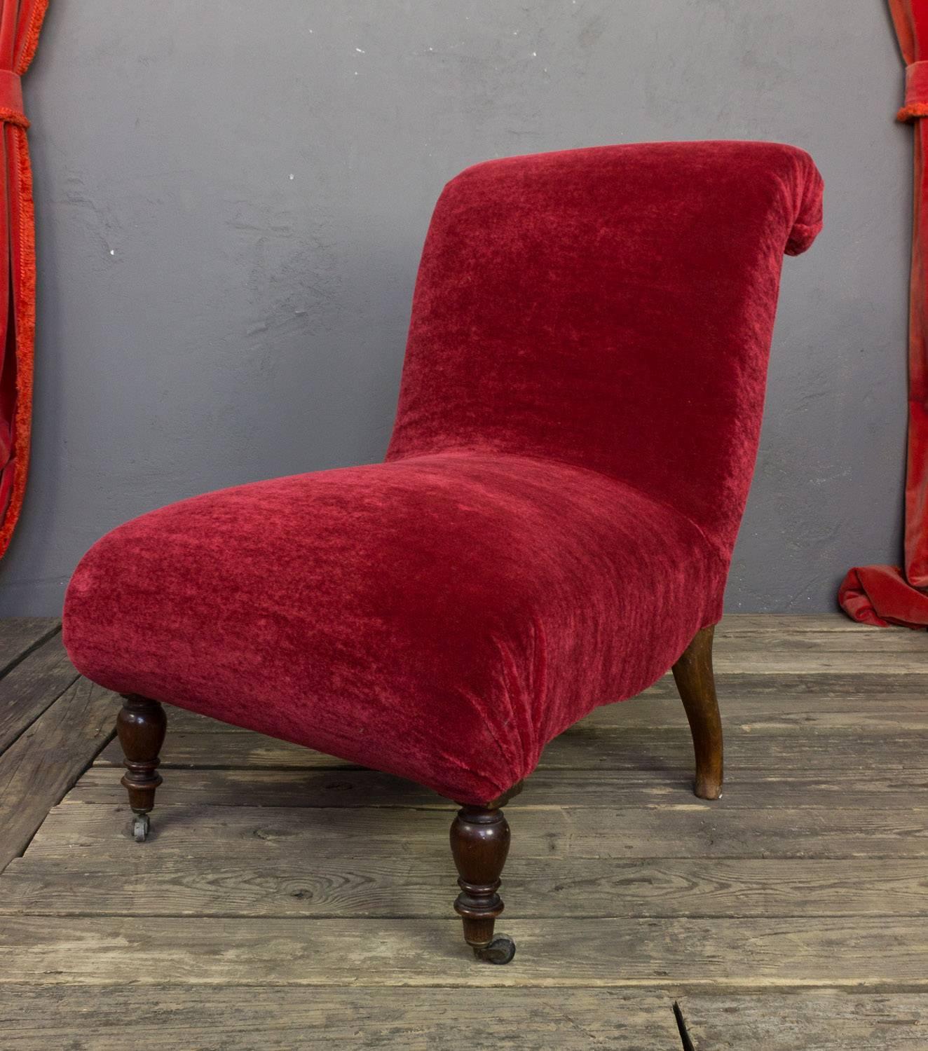 An elegant Spanish mid 19th century scrollback slipper chair. With its rich red mohair upholstery, this slipper chair is sure to be a standout in any room or setting. Recently upholstered, it is still in very good vintage condition, providing years