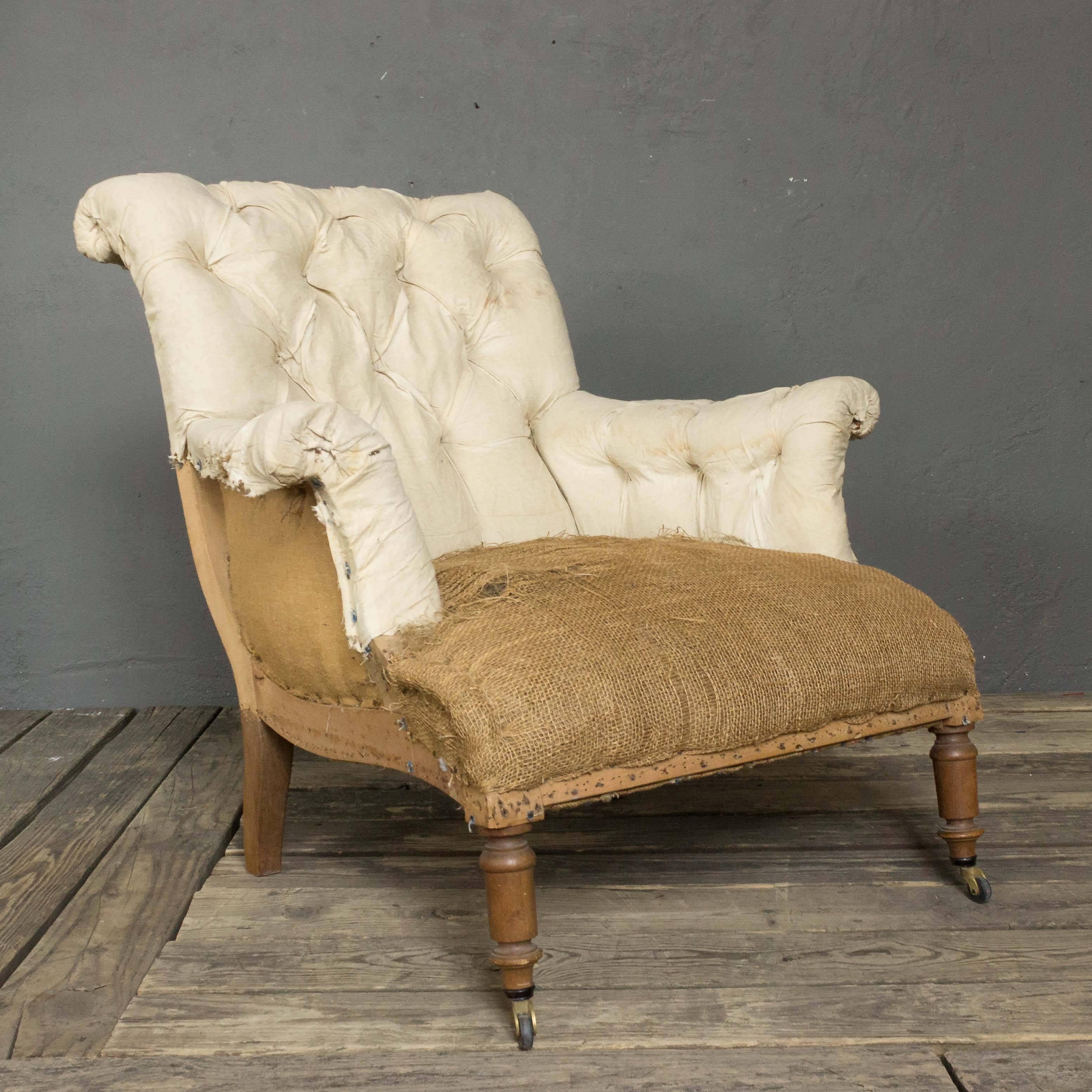 French 19th century Napoleon III armchair with turned legs and rolled back. The chair has been stripped down to the muslin and burlap and is ready to be upholstered. Sold as is.
 