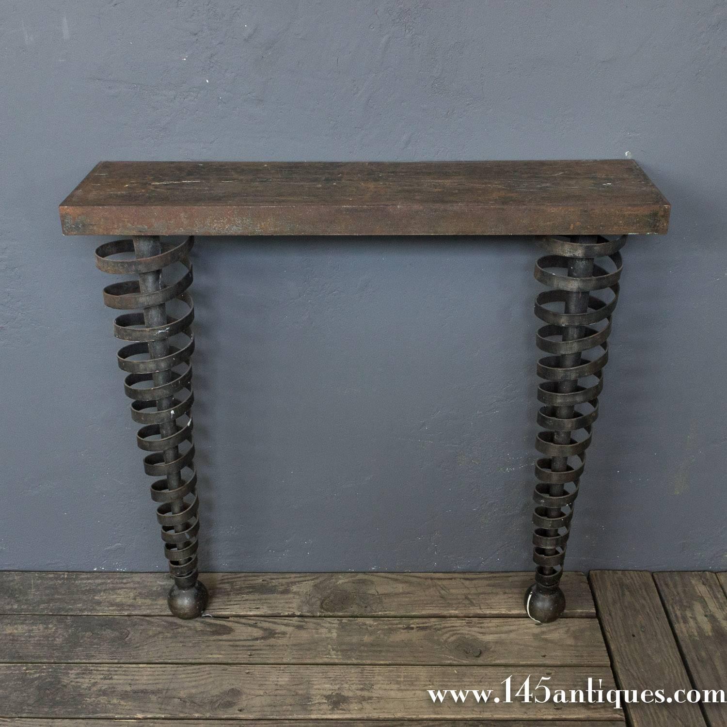 American 1990s wrought iron console with swirling iron banding and ball feet. Maybe designed to have a stone top. Sold as is.
