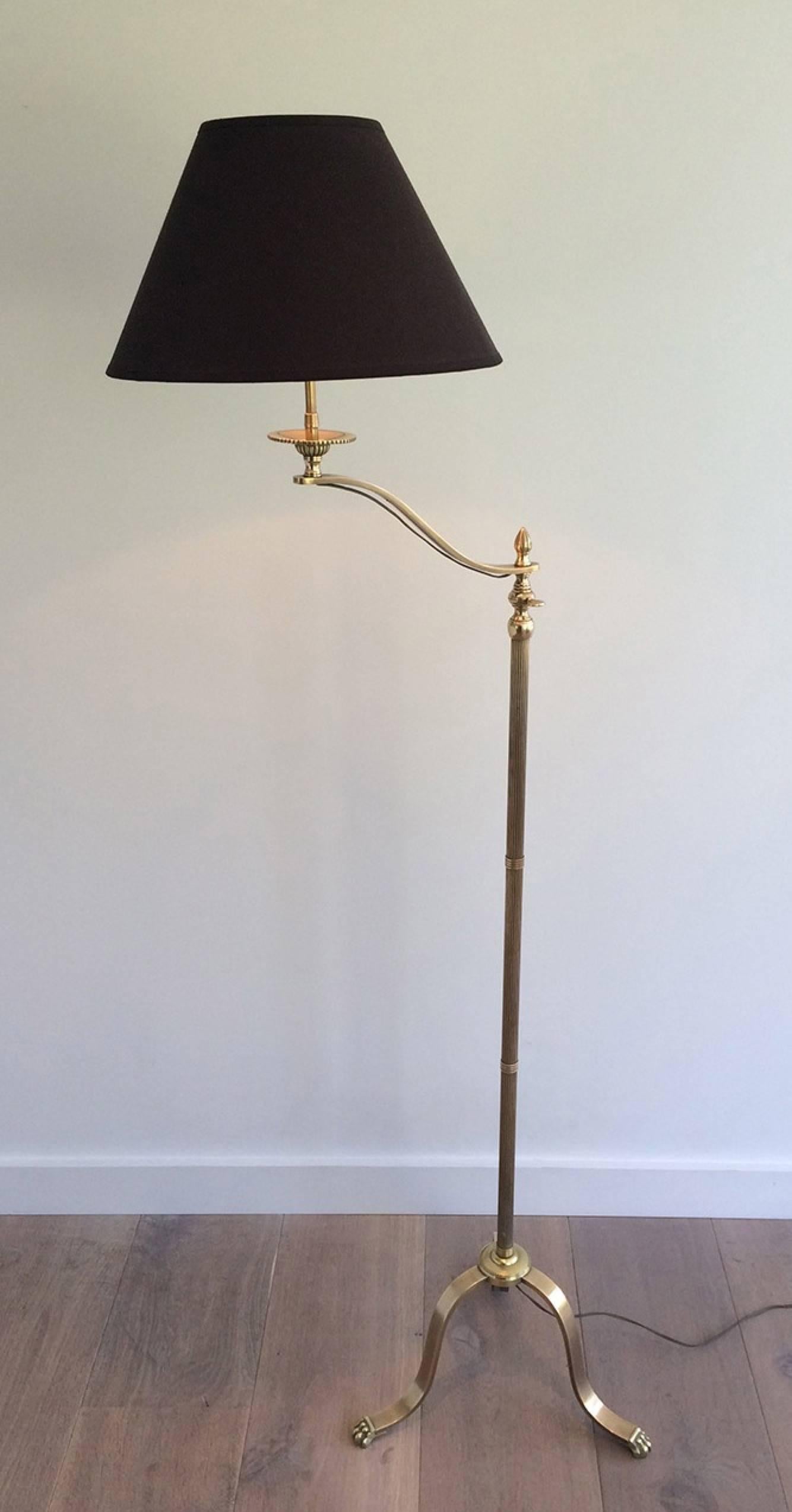 Pair of French neoclassical adjustable and swinging brass reading floor lamps with clawfeet by Maison Jansen.

This item is currently in France, please allow 2 to 4 weeks delivery to New York. Shipping costs from France to our warehouse in New