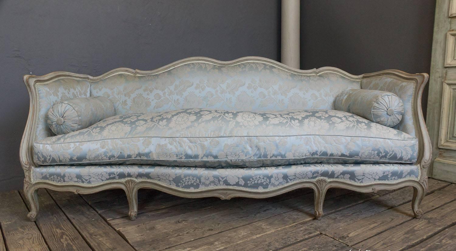French Louis XV style sofa with original patinated grey patina. Upholstered in fine Damask silk. Circa 1940's  attributed to Maison Jansen.