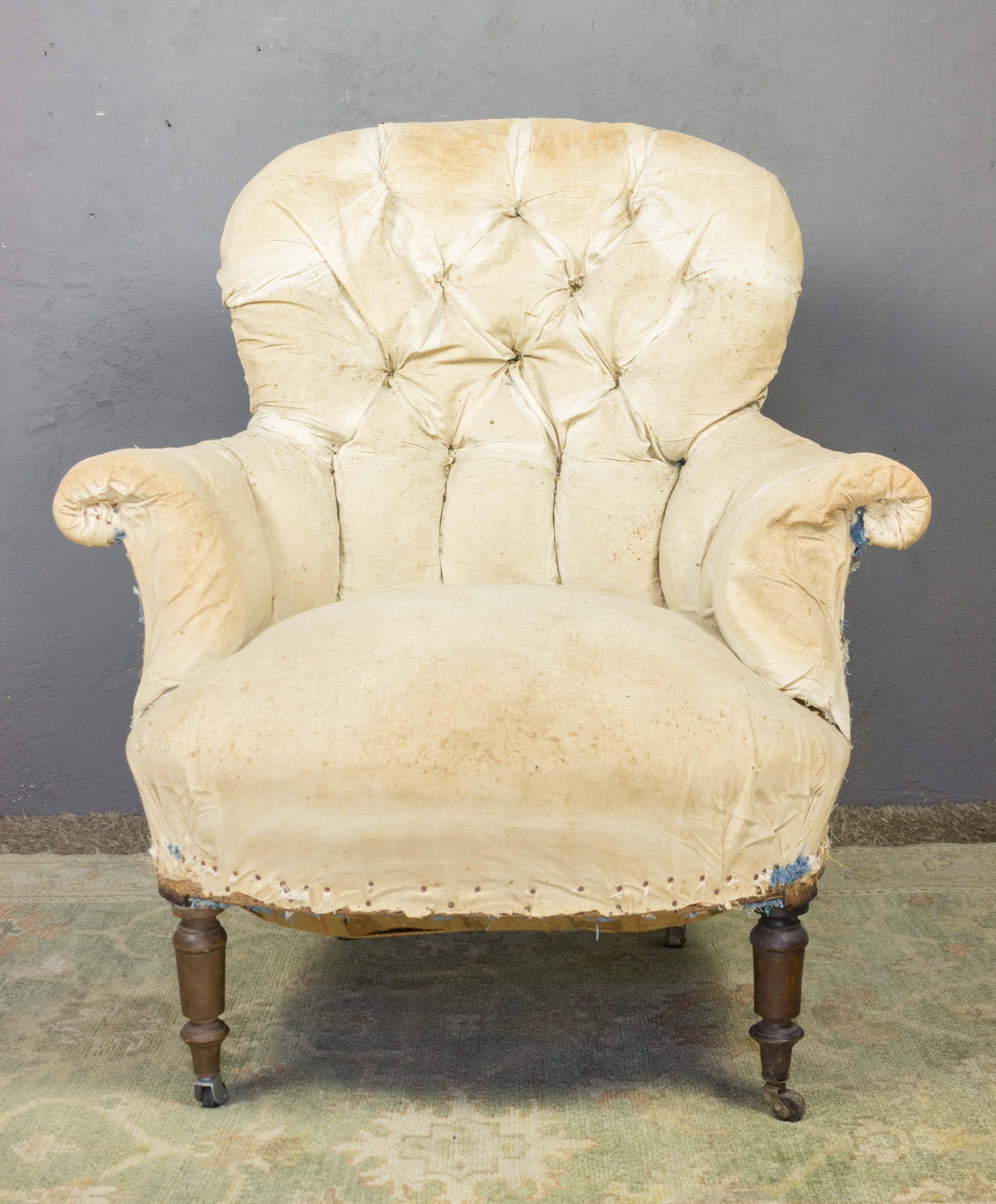 Pair of mid-19th century French armchairs with rounded tufted back. Stripped down to original muslin.