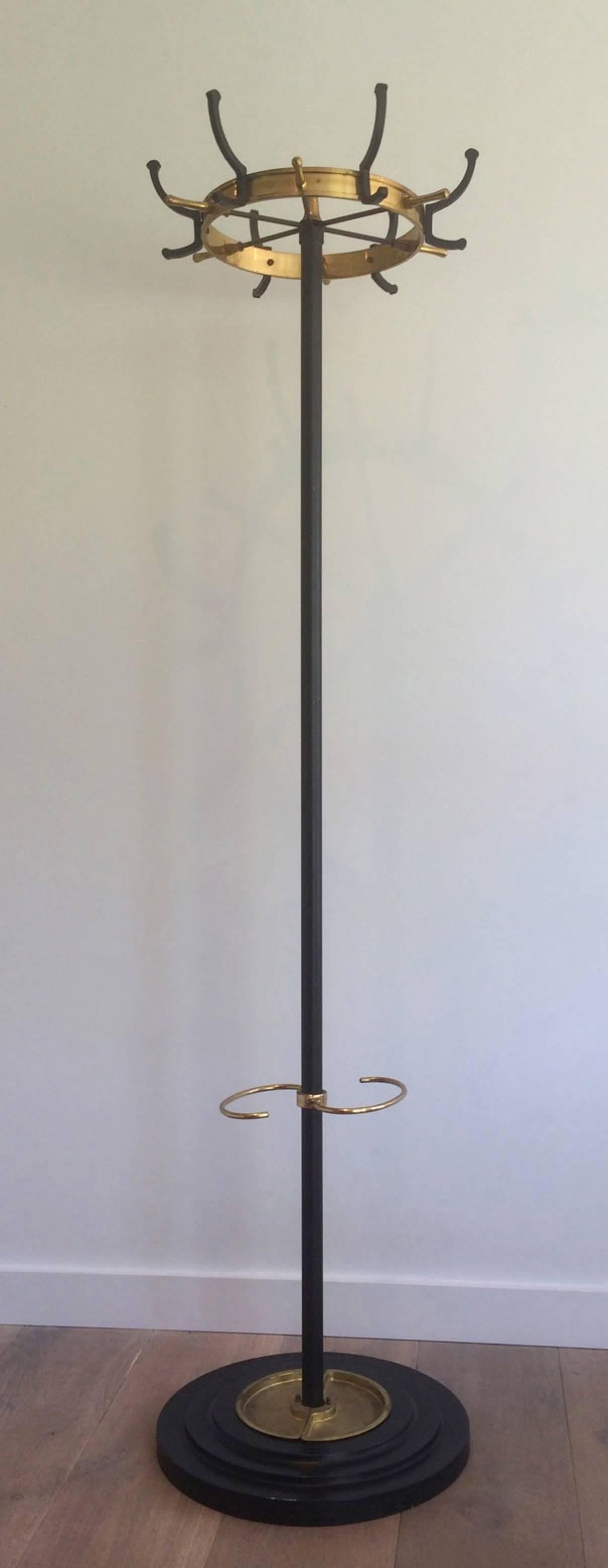 Black lacquered steel and brass coat rack with 12 hooks and brass umbrella stand at base, circa 1940.

This coat rack is currently in France, please allow 2 to 4 weeks delivery to New York. Shipping costs from France to our warehouse in New York