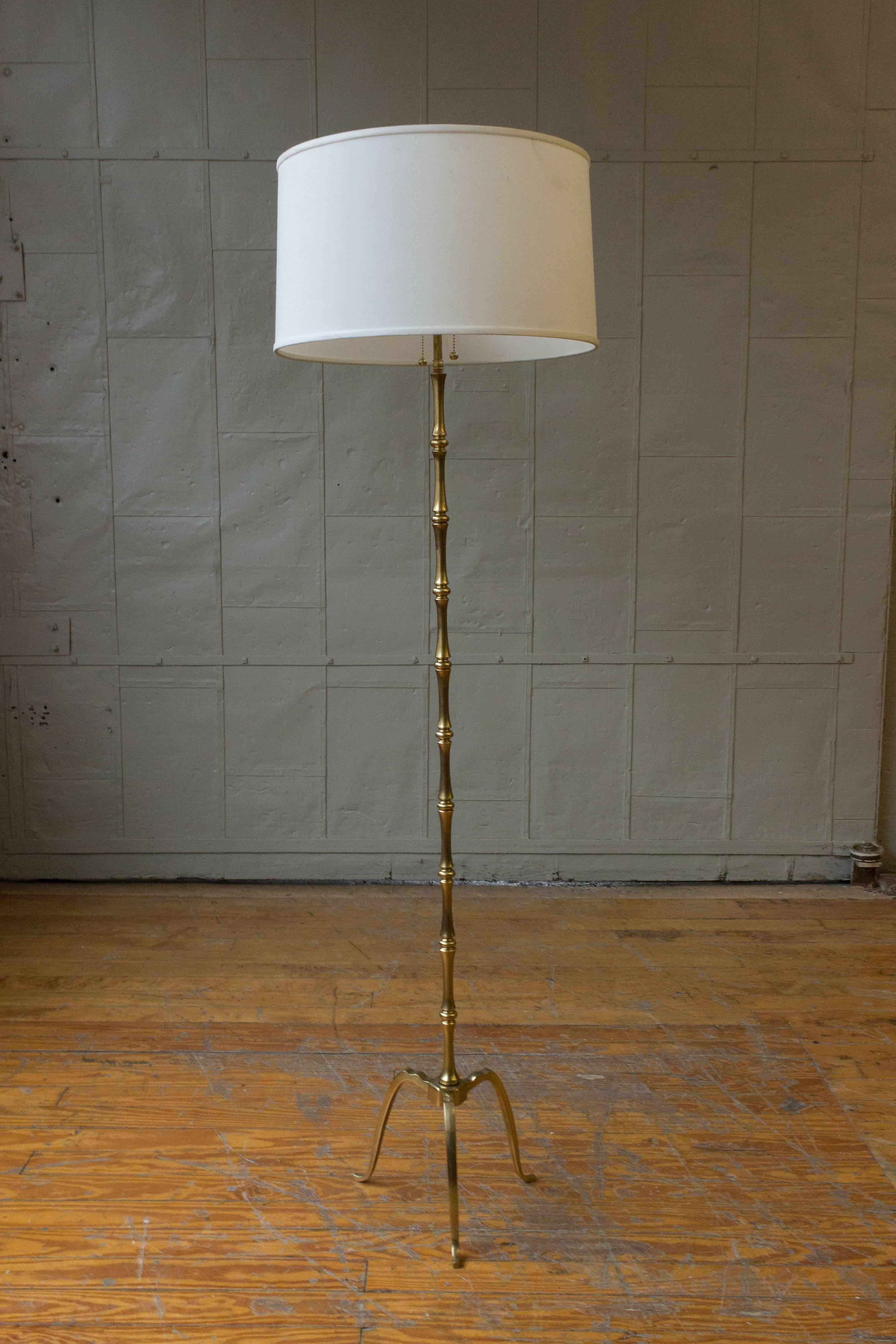 Gilt bronze and brass floor lamp on a tripod base, French, 1940s. Shade not included.

