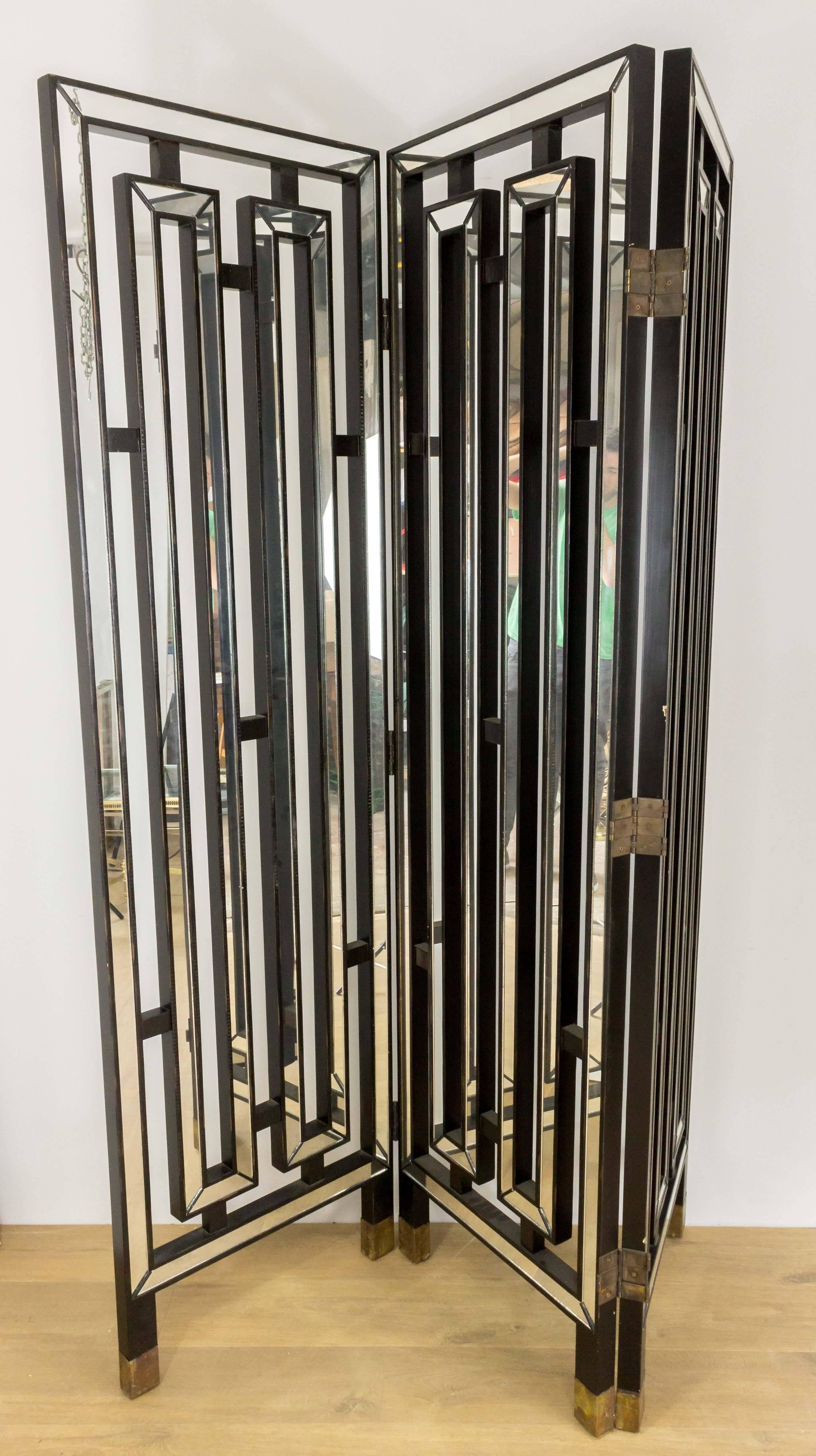 Modern French black wood screen with bevelled mirror on both sides. This heavy screen has brass sabots. This screen has threes panels that are hinged together (24 inches wide each). 

This piece is still in France, please contact us for delivery