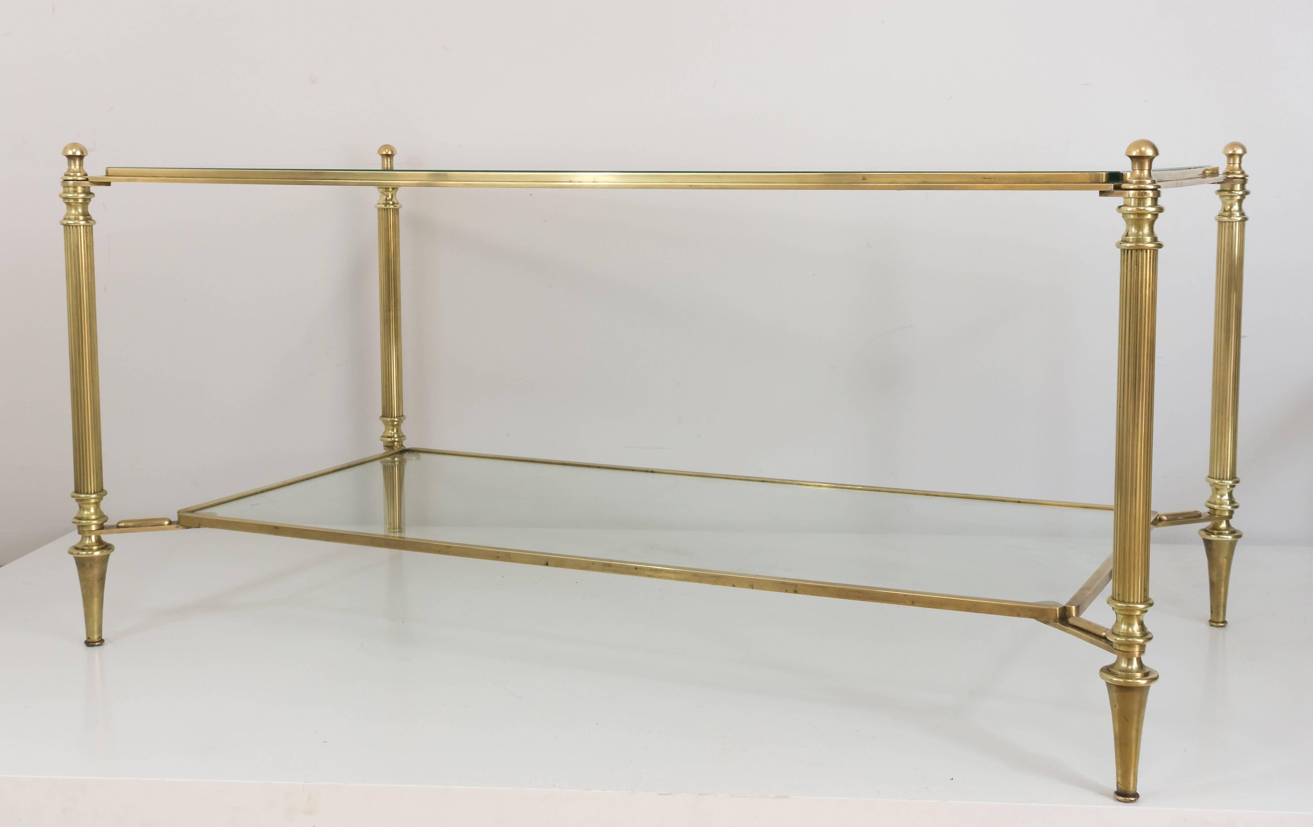 Brass coffee table with glass shelves, fluted legs with simple ball finials with a suspended lower shelf, French, circa 1940s.