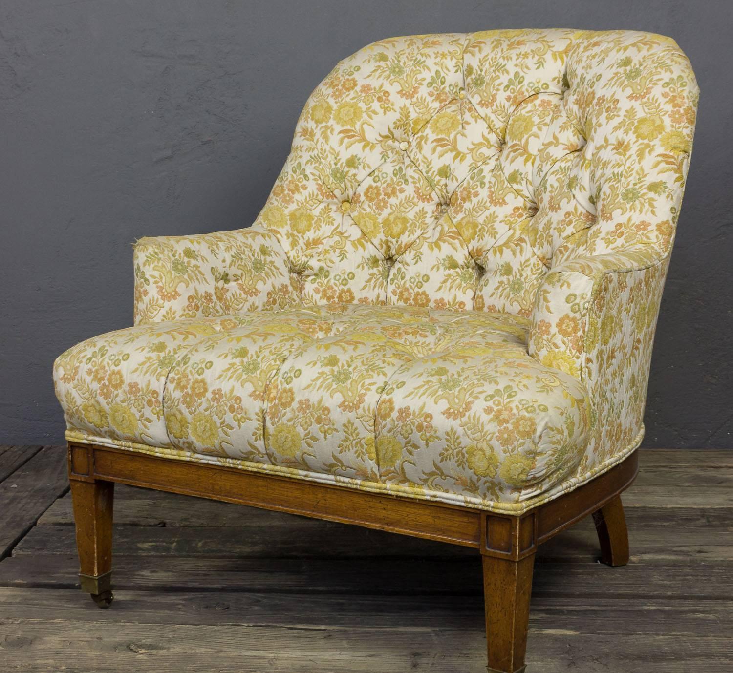 The pair of 1940s American tub chairs with tufted backs and wooden trim and legs. These chairs are in great condition; structure is tight and upholstery is clean, albeit dated. Light marks visible to leg finish. Frame finish can be stained or