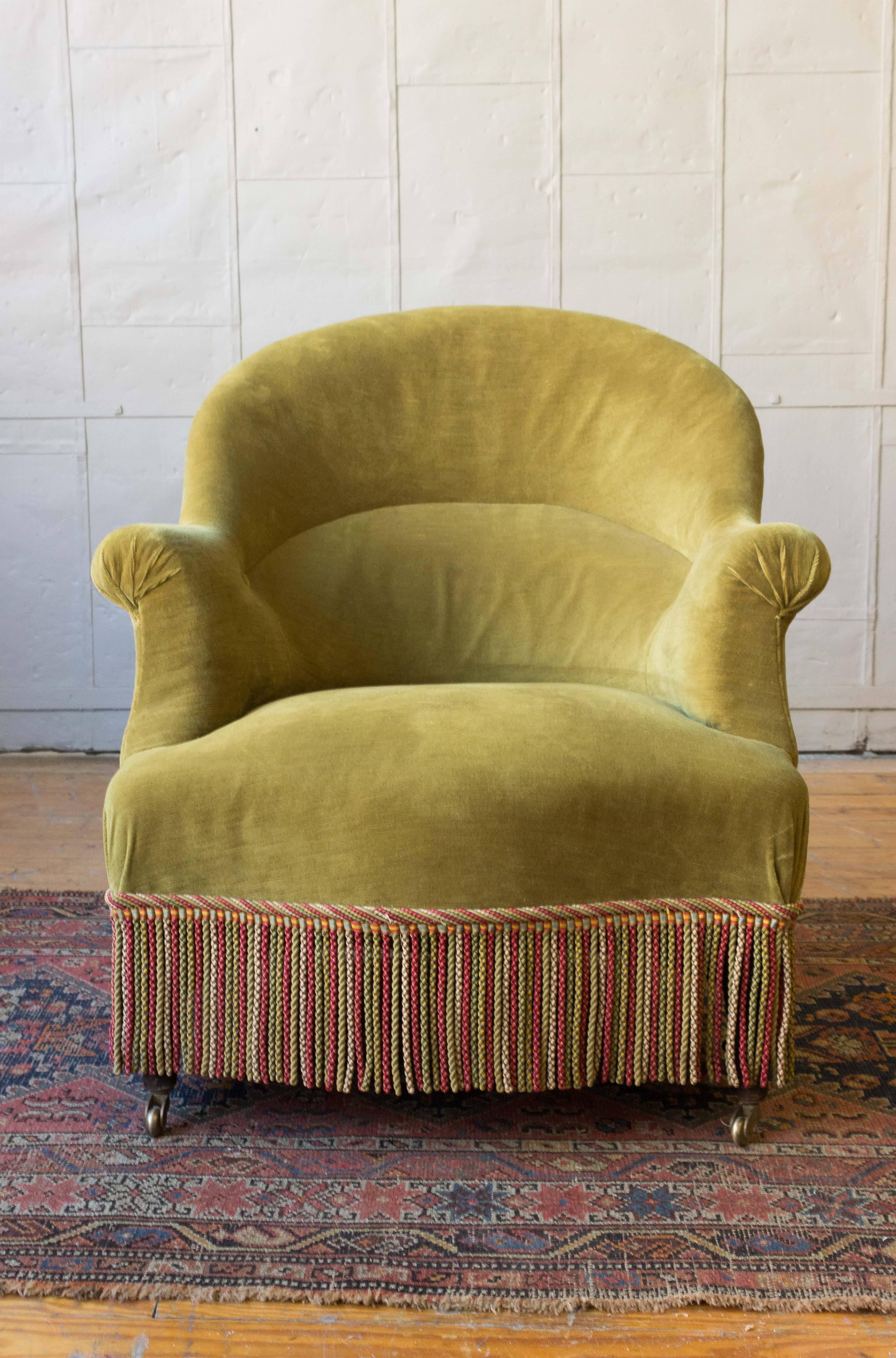 Pair of French Napoleon III armchairs in green velvet with bouillon fringe. 