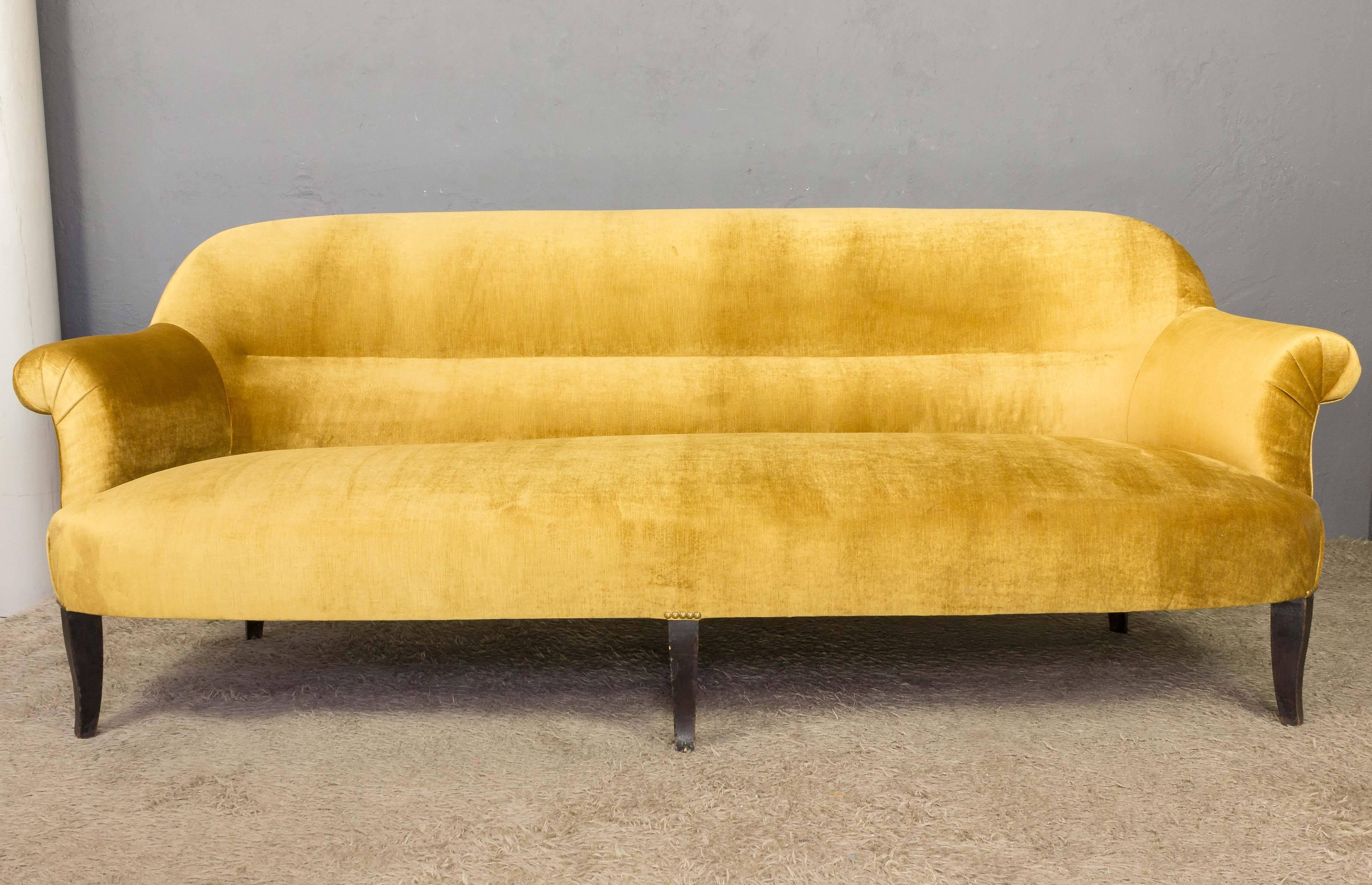 Wonderful French settee, most likely made circa 1900. The gracious curved back has lumbar supports and rolled arms. The settee has as additional front leg for extra stability, and has been reupholstered with gold velvet.