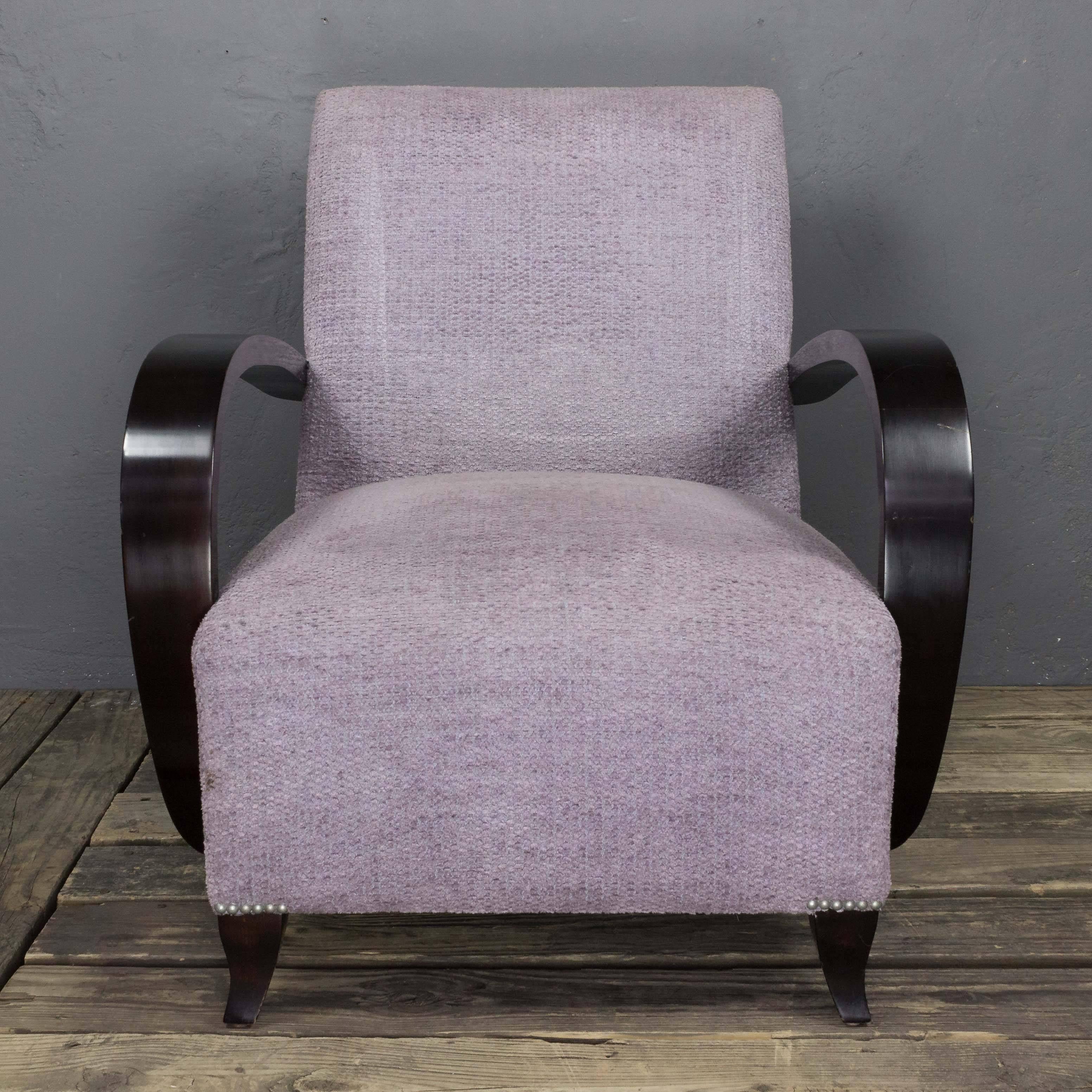 A newly manufactured Meg club chair. Add a classic touch to your home with this newly manufactured re-edition of a 1940s French club chair. Crafted with curved wooden arms and turned feet, it is available in your choice of dark brown or flat black