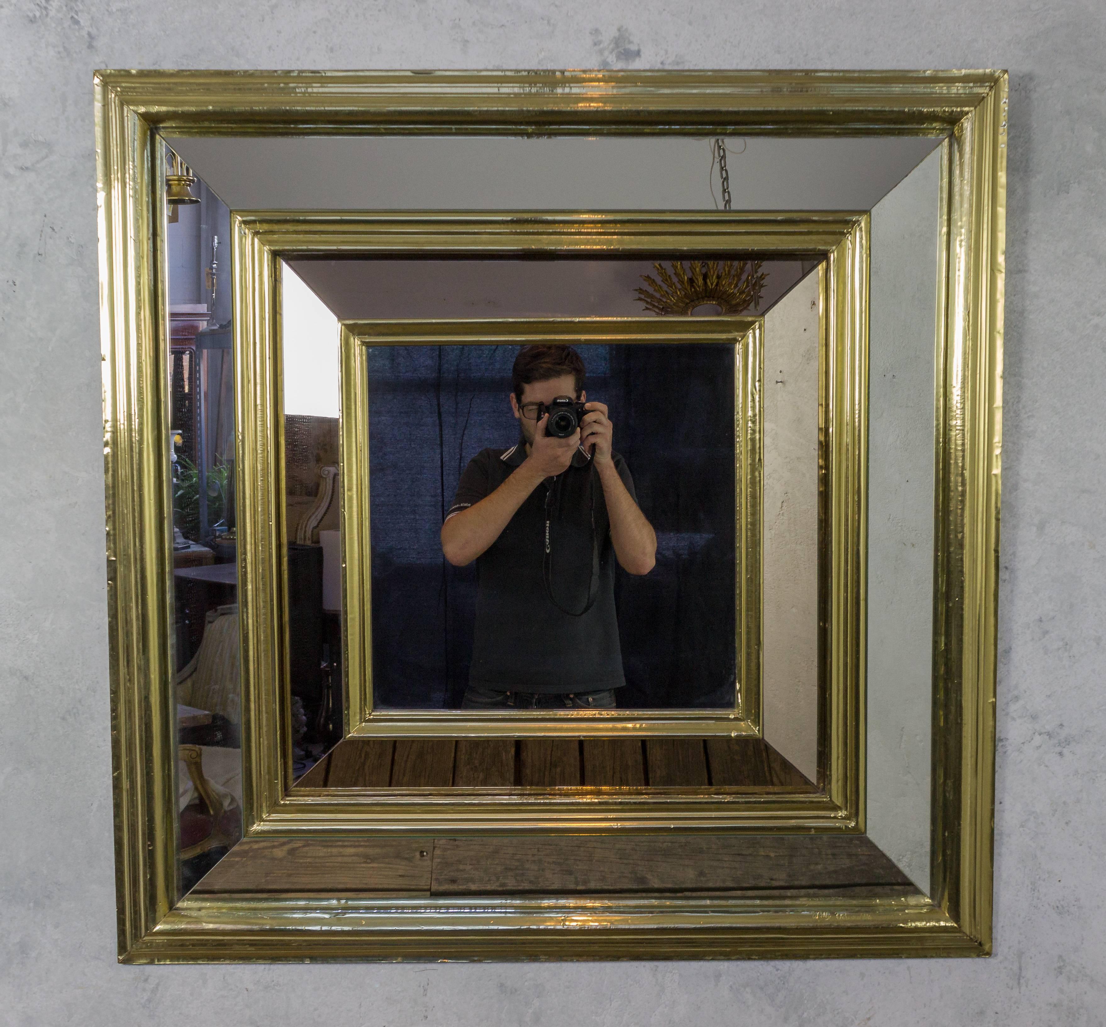 Large French 1960s square mirror with double mirrored frame with bronze and silver mirror, in a brass foil wrapped frame.

Ref #: DM0106-35

Dimensions: 43