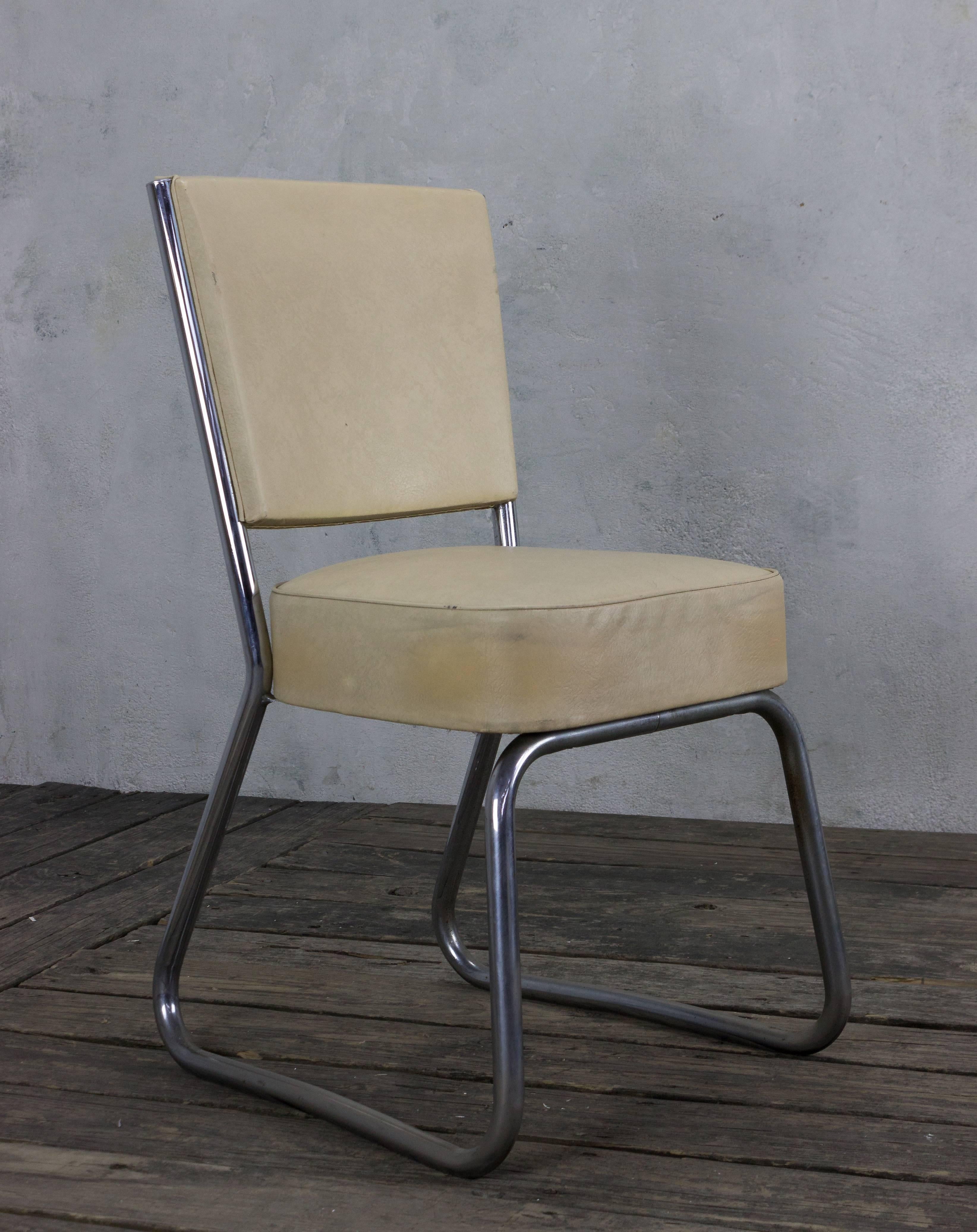 A fabulous set of four chrome and vinyl chairs. Make a bold mid-century statement with this set of four chairs, including three side chairs and one armchair. The ensemble is made from chrome-plated tubular steel frames and still has the original