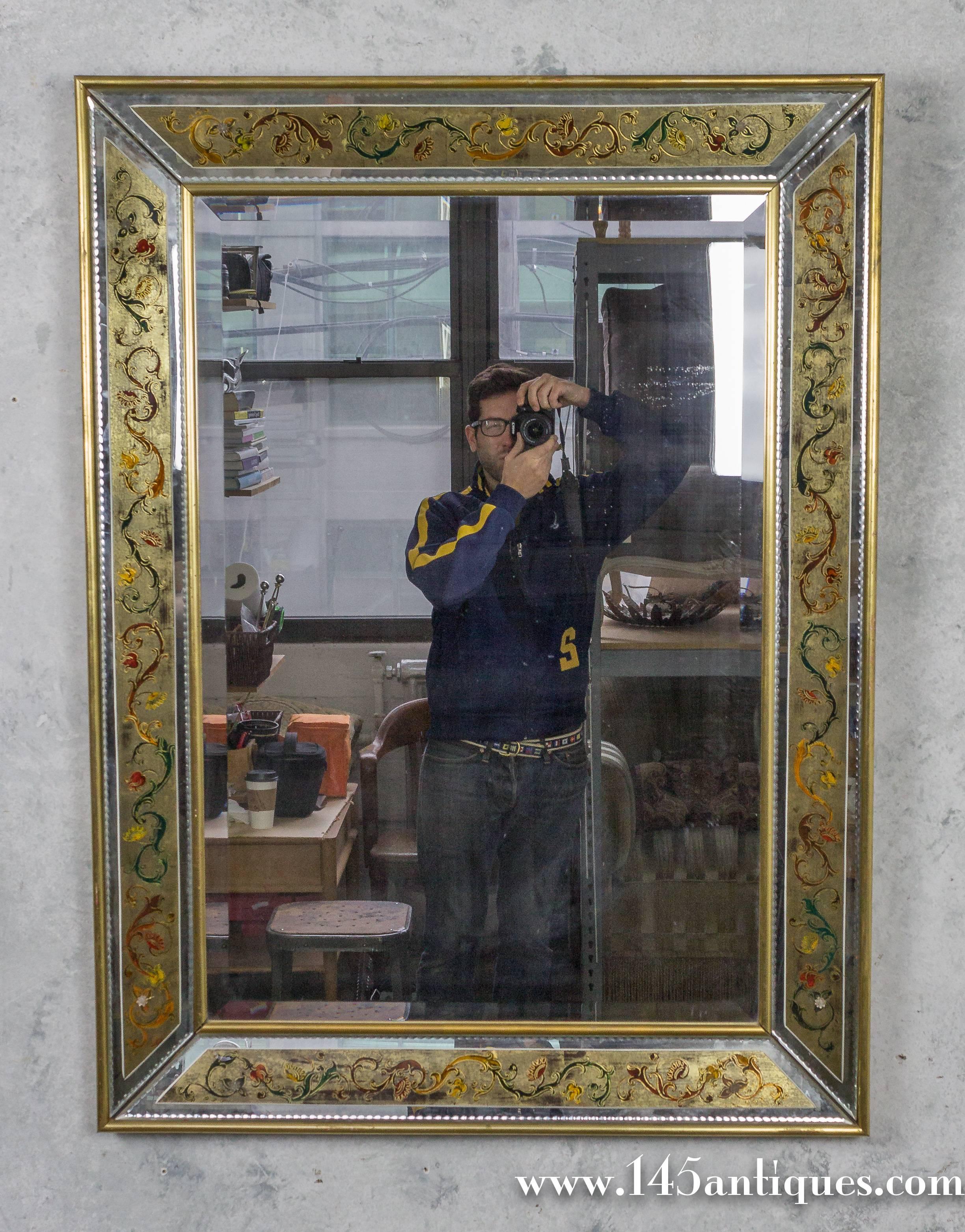 French, 1940s reverse painted mirror with gilt wood  frame and trim.