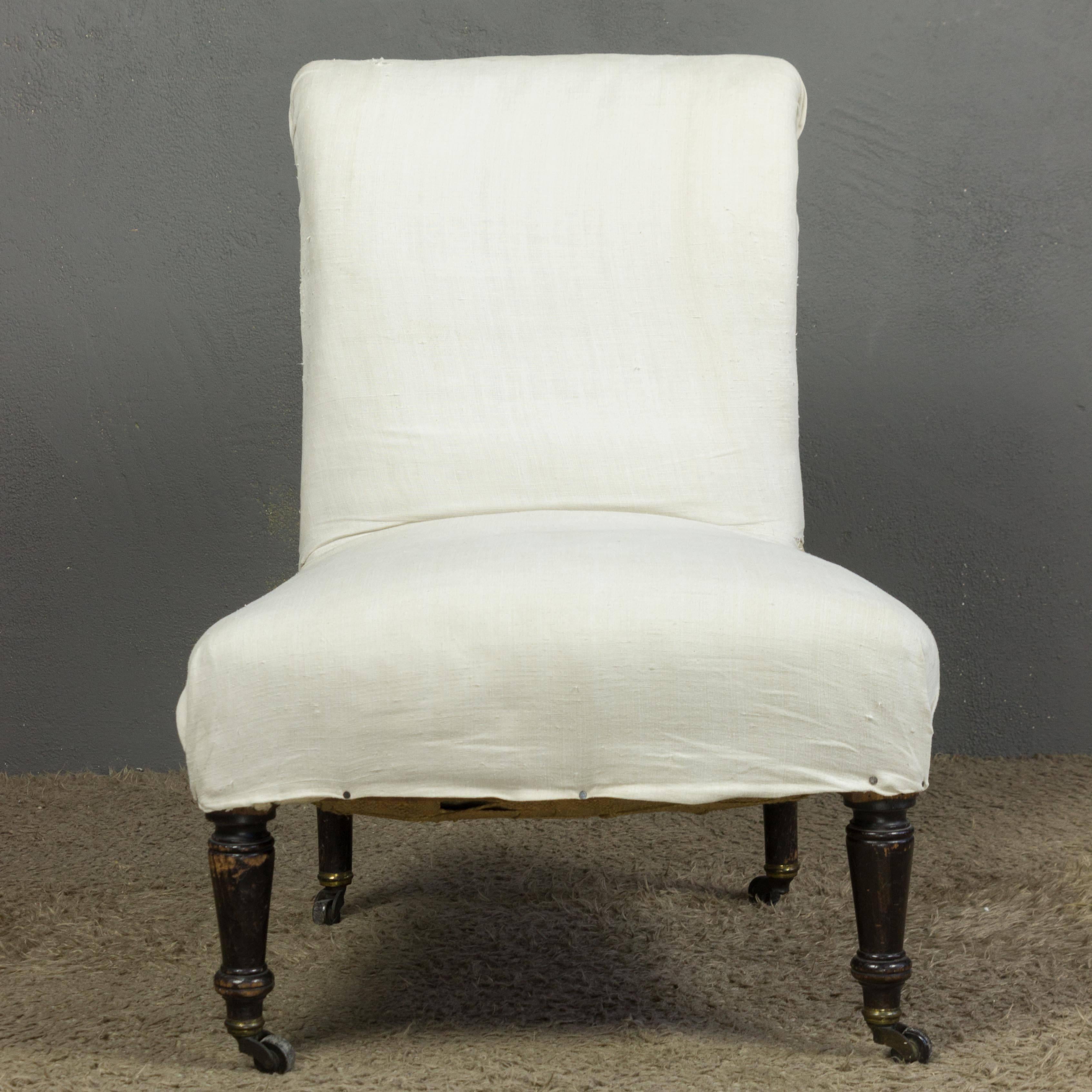 French Napoleon III slipper chair with rolled back in muslin. This piece is sold in 