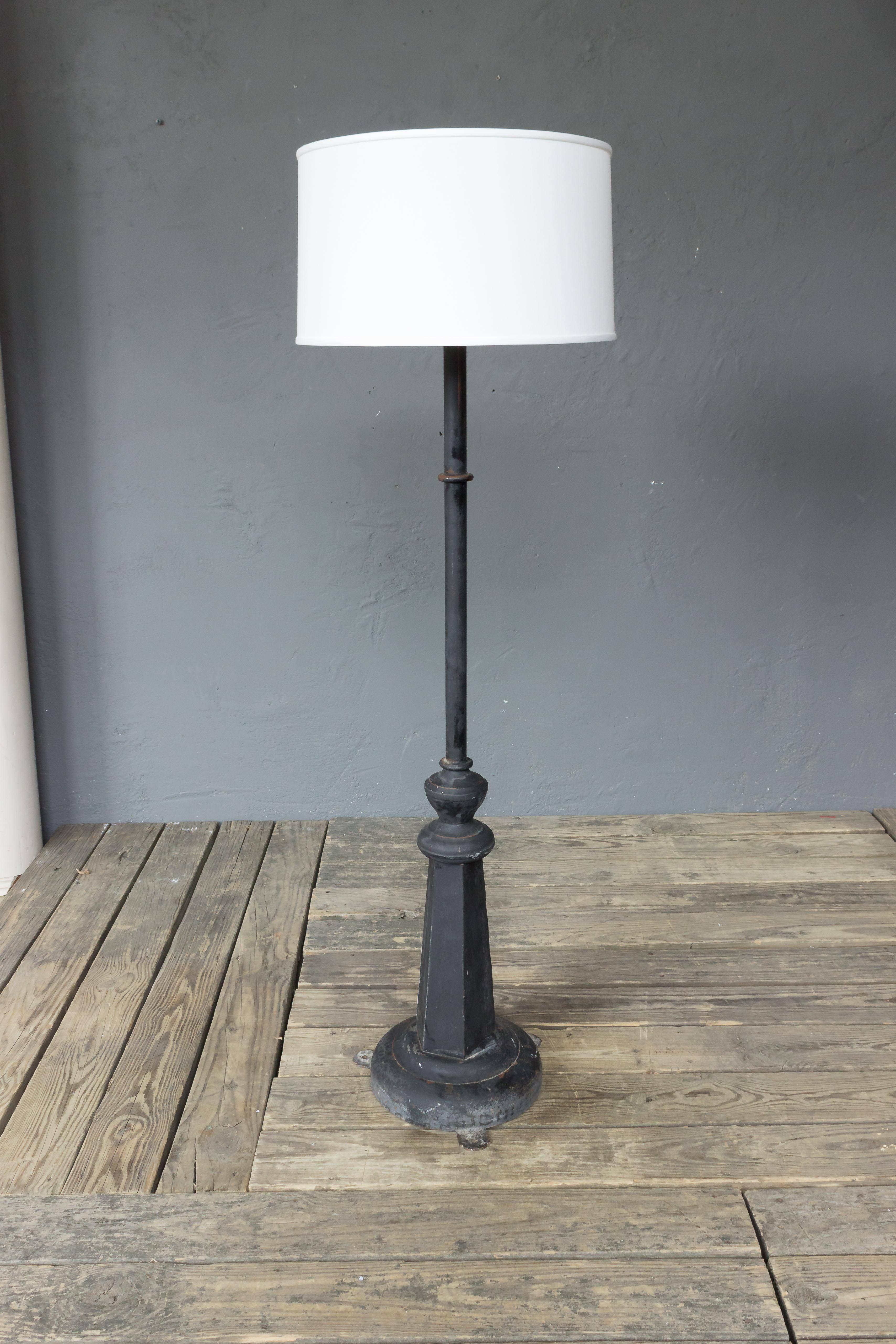 An unusual French floor lamp that was converted from a street or factory lamp. Made of metal, and the base is heavy iron, and can be attached to the floor. The floor lamp can also be fitted with a lantern for exterior use. There are three available.