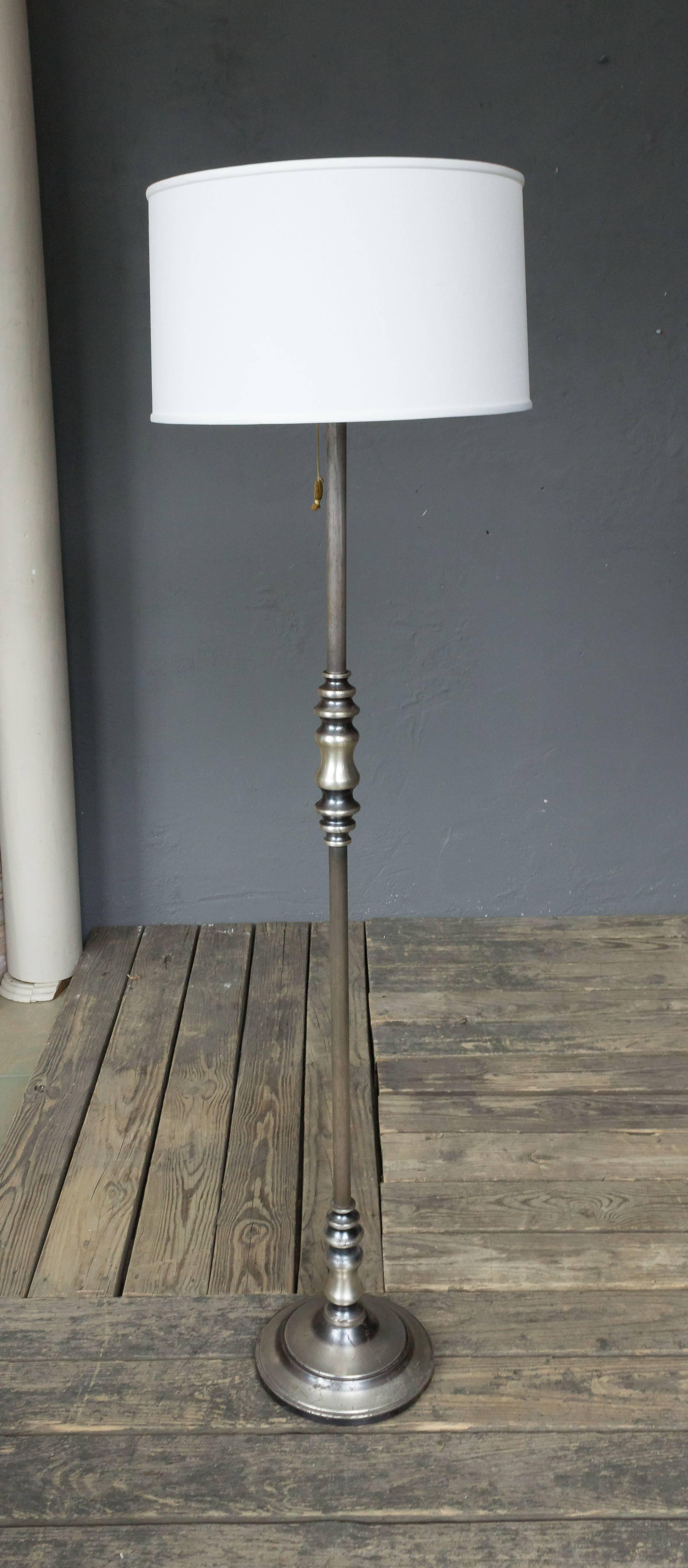 An interesting brass and metal floor lamp that has original silvered finish with darker patinated areas for contrast. French, 1950s.
Price includes hand polishing and new wiring. The plating is original and shows tarnishing and wear. The item is