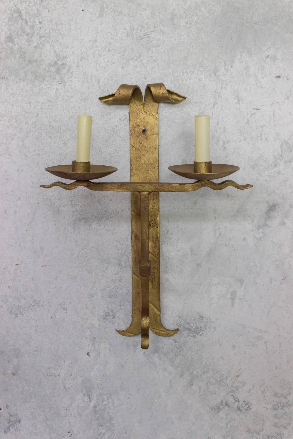 French wrought iron sconces with scrolled heads, circa 1950.