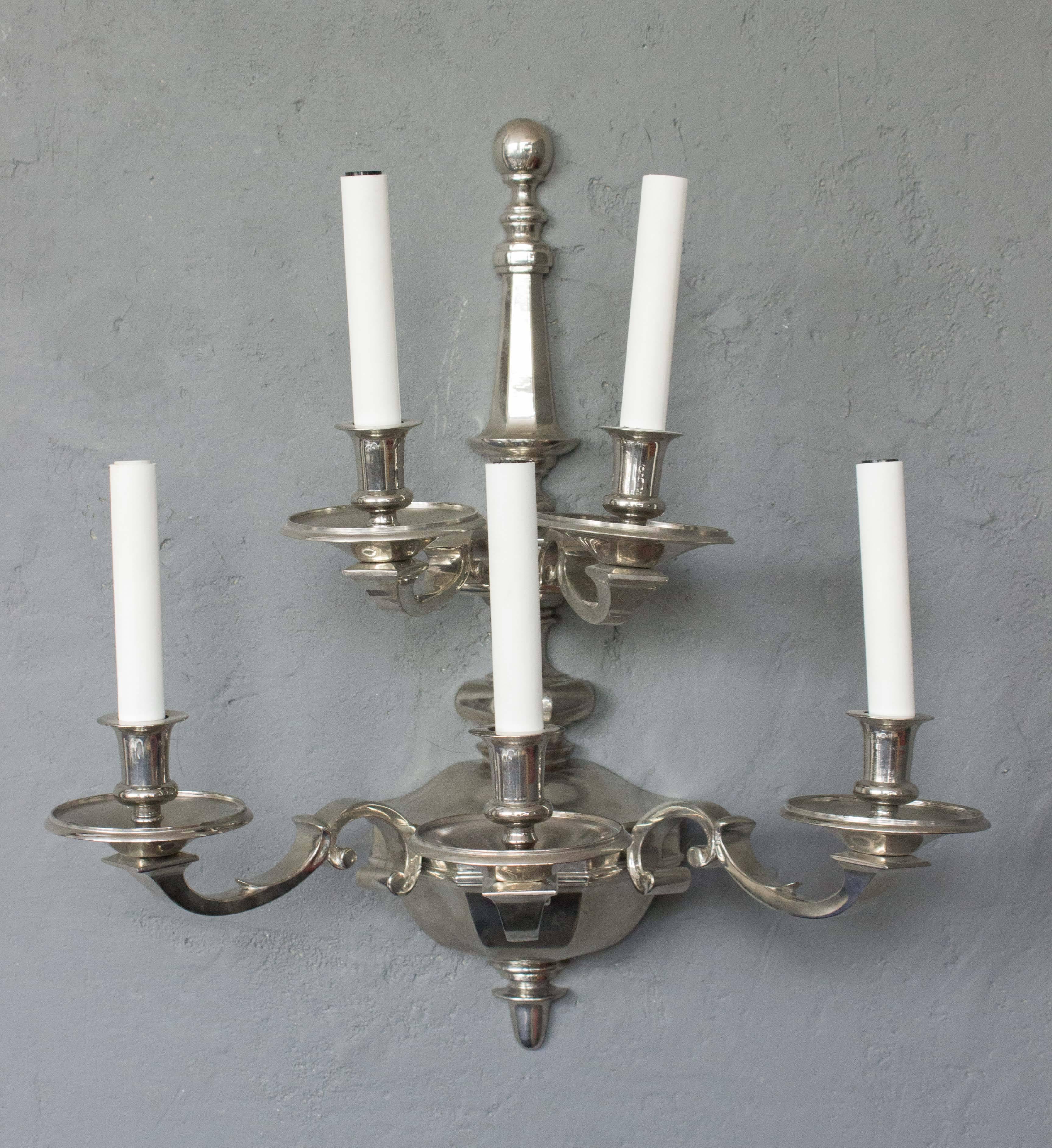 This pair of French sconces from the 1940s is an epitome of elegance and classic Neo-Baroque style. Featuring a two-tiered design with five arms on each piece, they are composed of nickel-plated bronze, a testament to their vintage charm. While