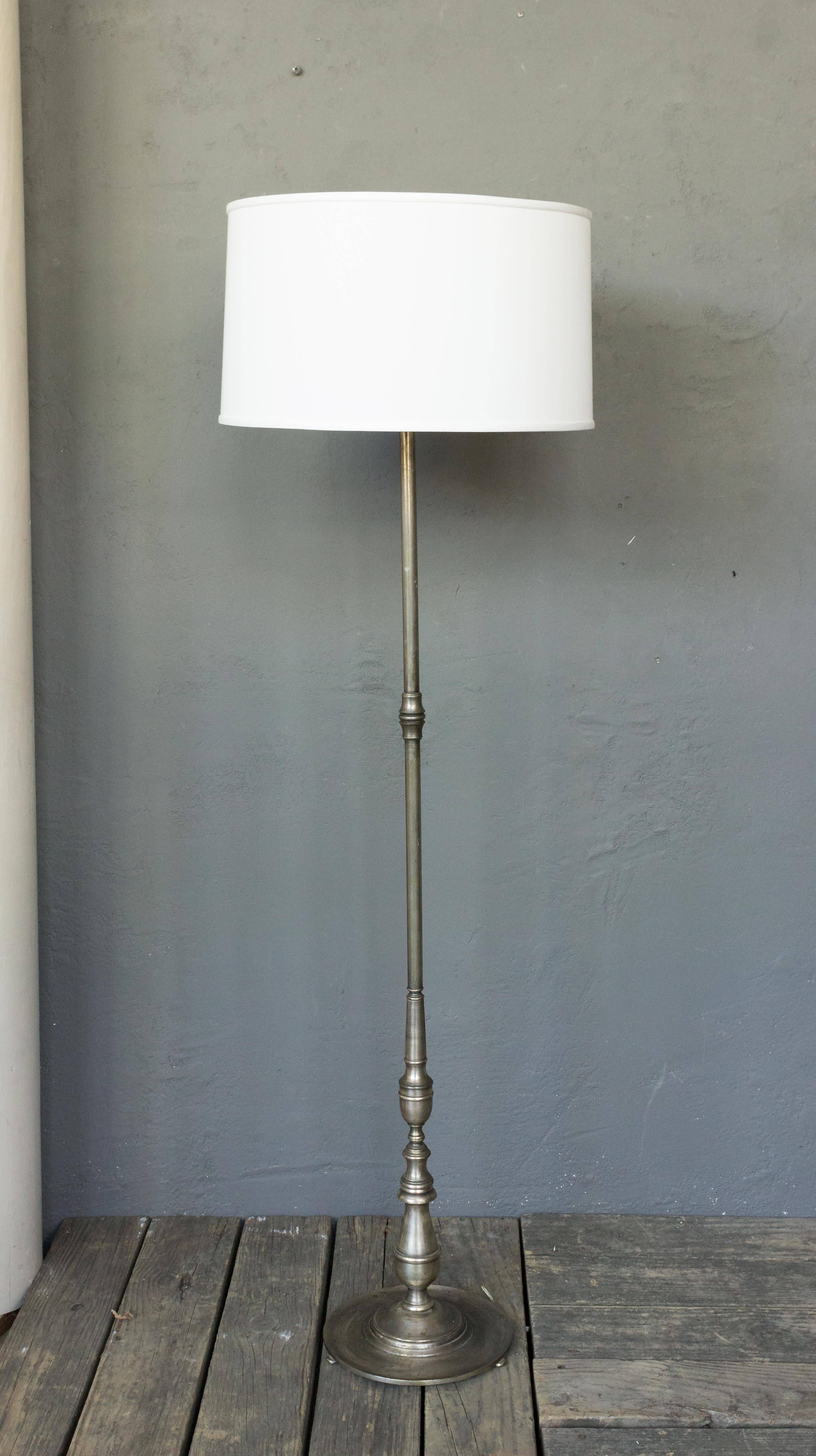 Classic 1940's French floor lamp with a rich silvered patina on a sturdy round base.

Price includes polishing or plating and new wiring. Please allow 2 to 3 weeks for completion. Not sold with shade (photographed with 10"H x 18" Diameter
