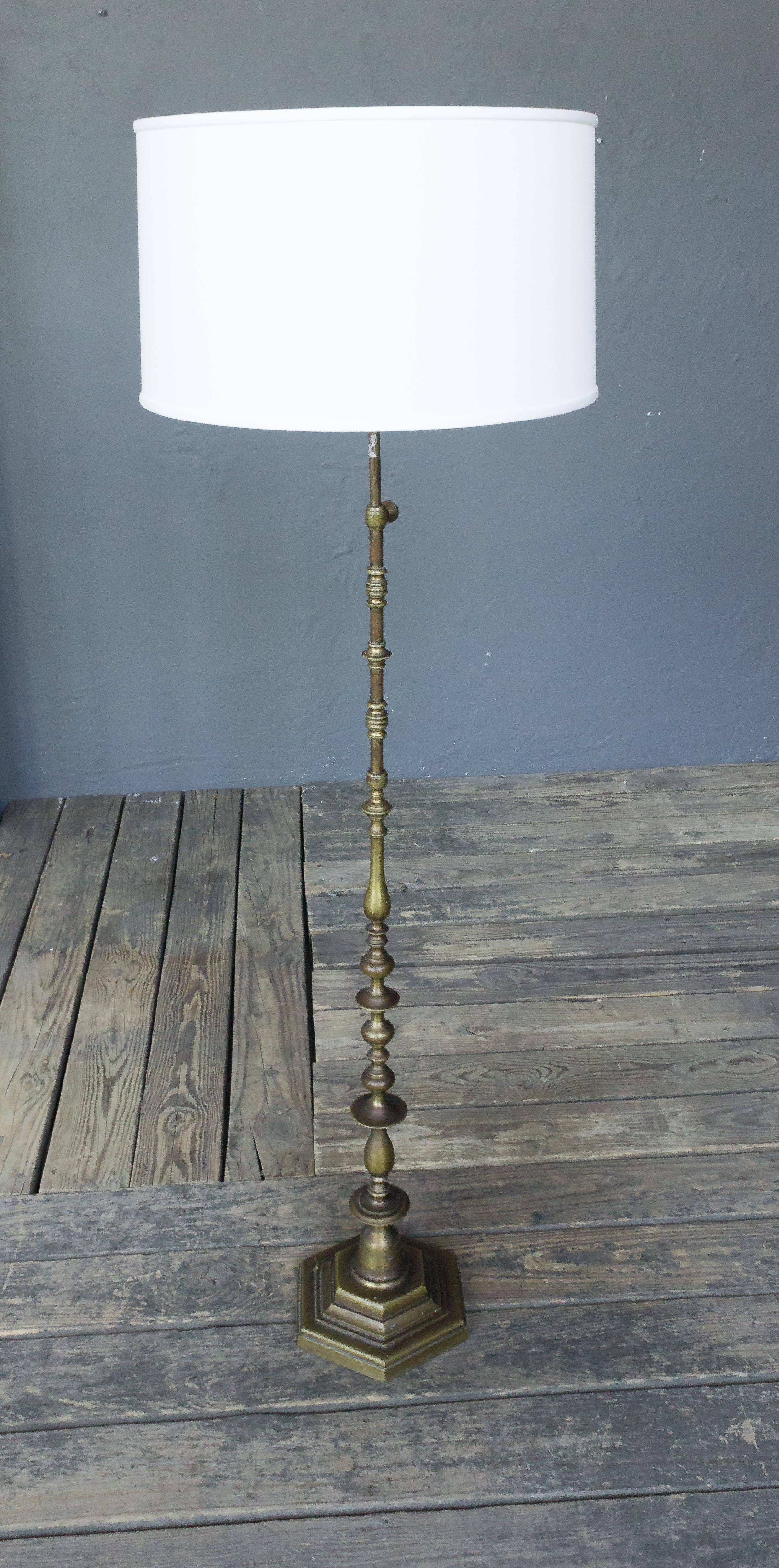 Patinated bronze floor lamp on hexagonal base with adjustable height.

Price includes polishing or plating and new wiring. Please allow 2 to 3 weeks for completion. Not sold with shade (photographed with 10 inch H x 18 inch Diameter shade). 