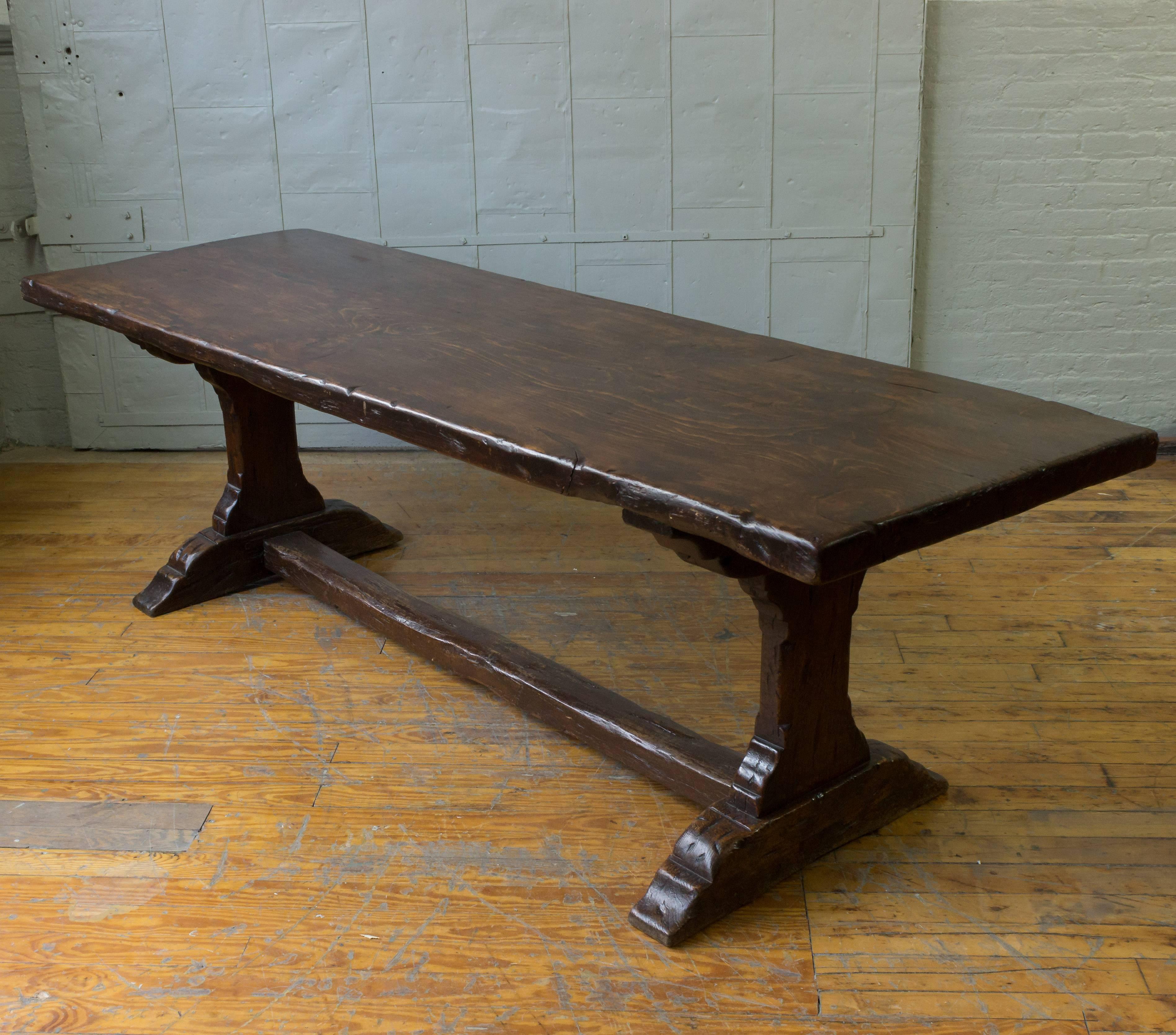 Early 19th century, French monastery table made from walnut. The top is made from a single piece of wood.