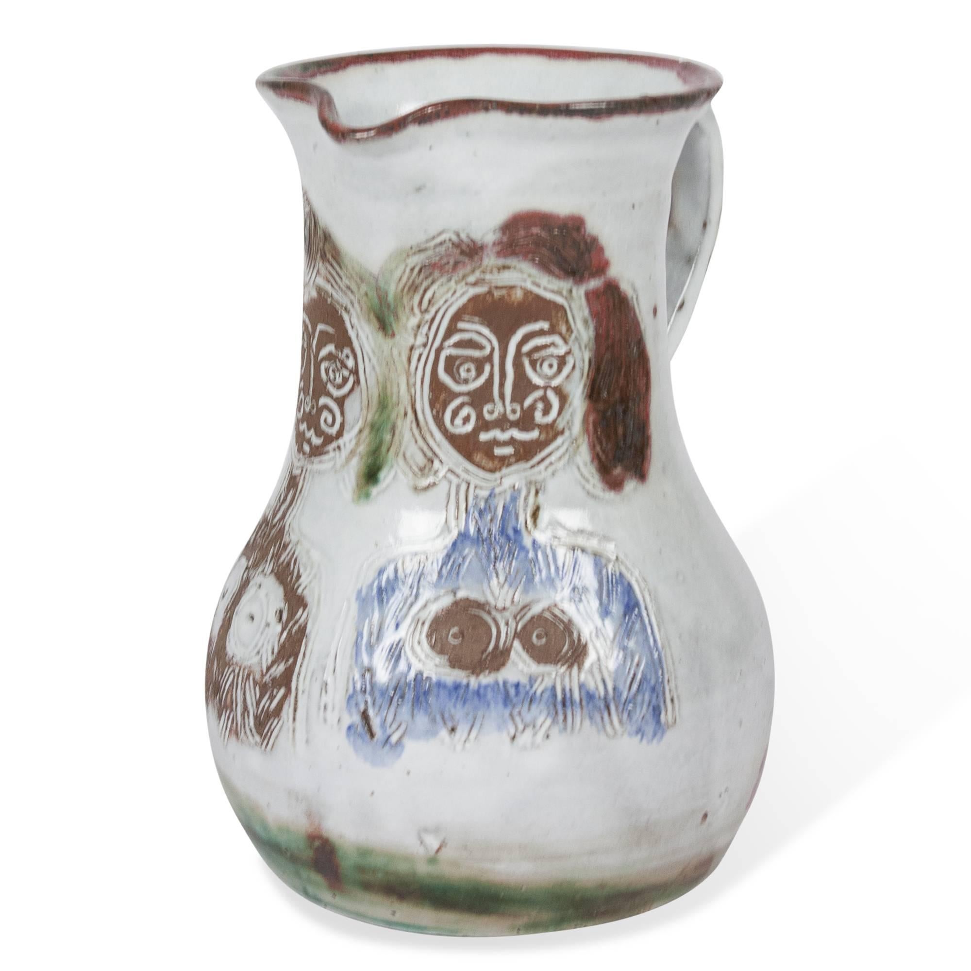 Glazed stoneware pitcher, decorated with an image of two females by Albert Thiry, French, circa 1950. Signed to underside. Measures: 5” D, 7” W, 10.5” H. (sats)