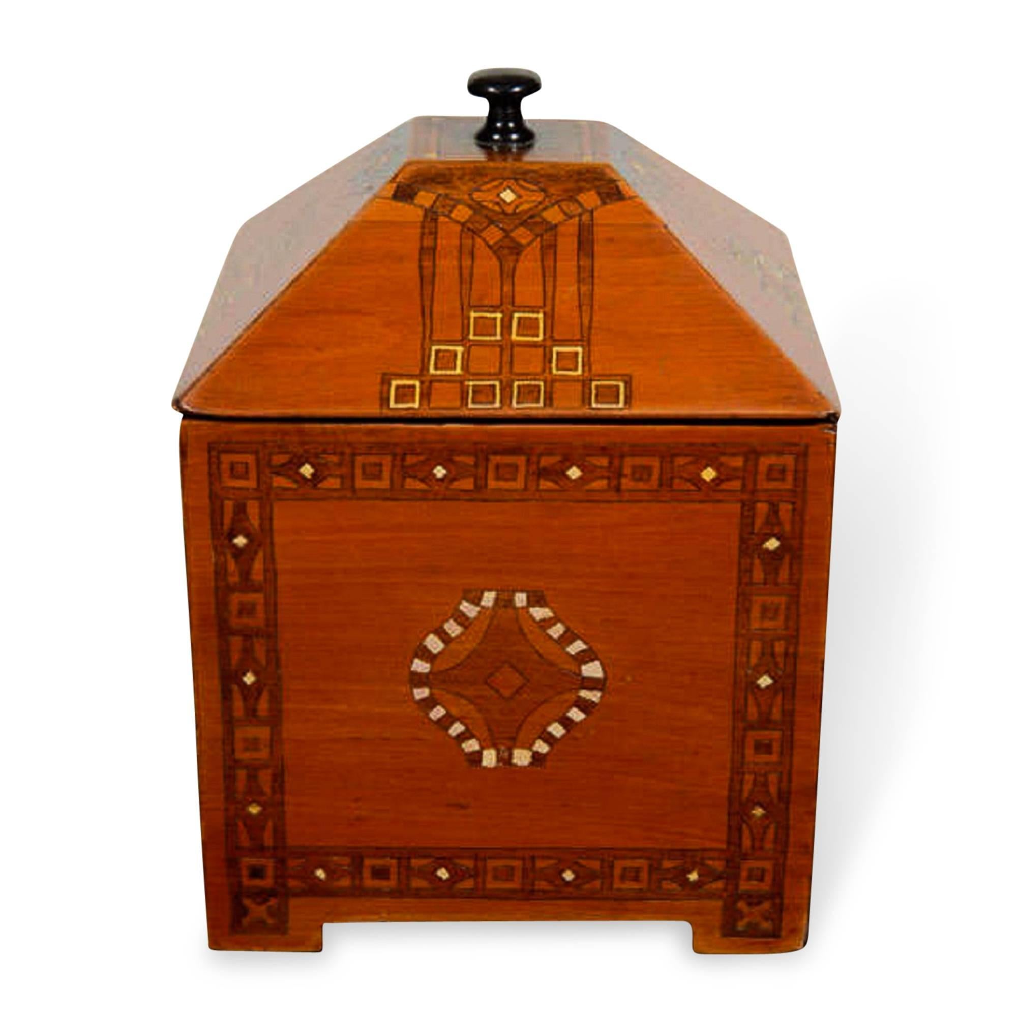 Small wooden box with decorative pattern created out of contrasting inlaid wood pieces, lidded. German, circa 1900. Measures: 5 in x 5 in, height 8 in. 